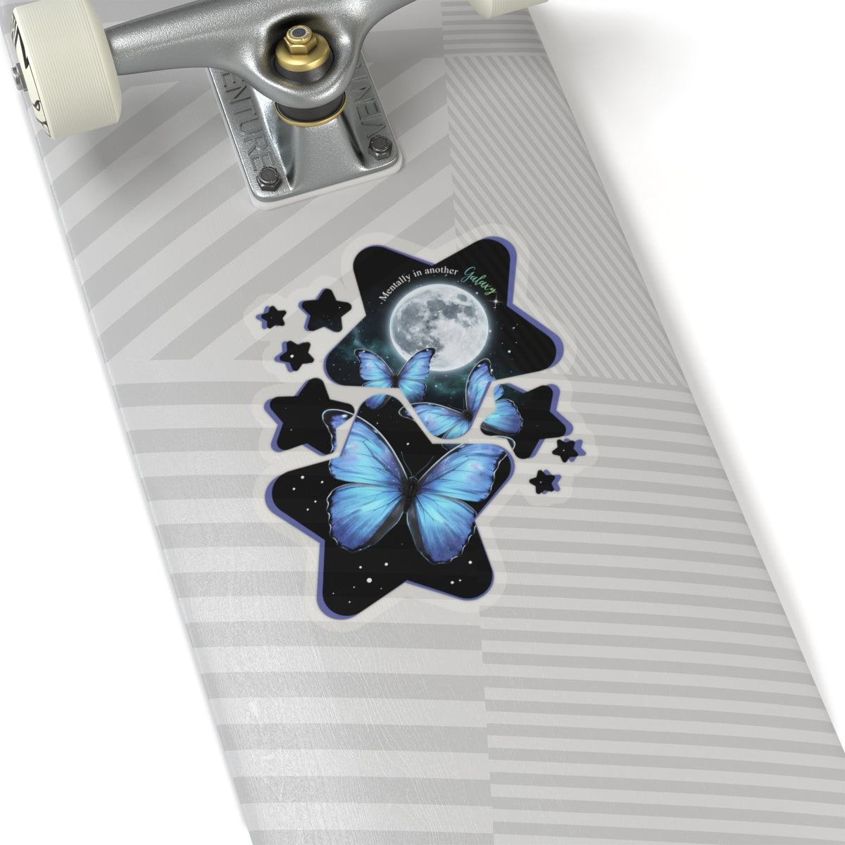 Skateboard with a blue morpho butterfly galaxy moon stars vinyl sticker on a white background