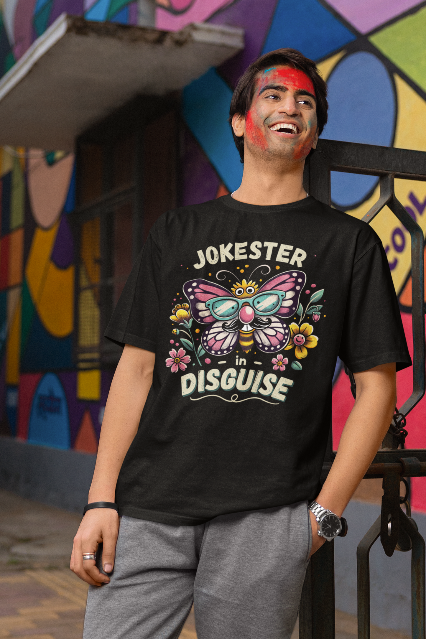 laughing man with colorful face paint wearing eco-friendly large butterfly prank t-shirt outdoors—quirky gift for pranksters