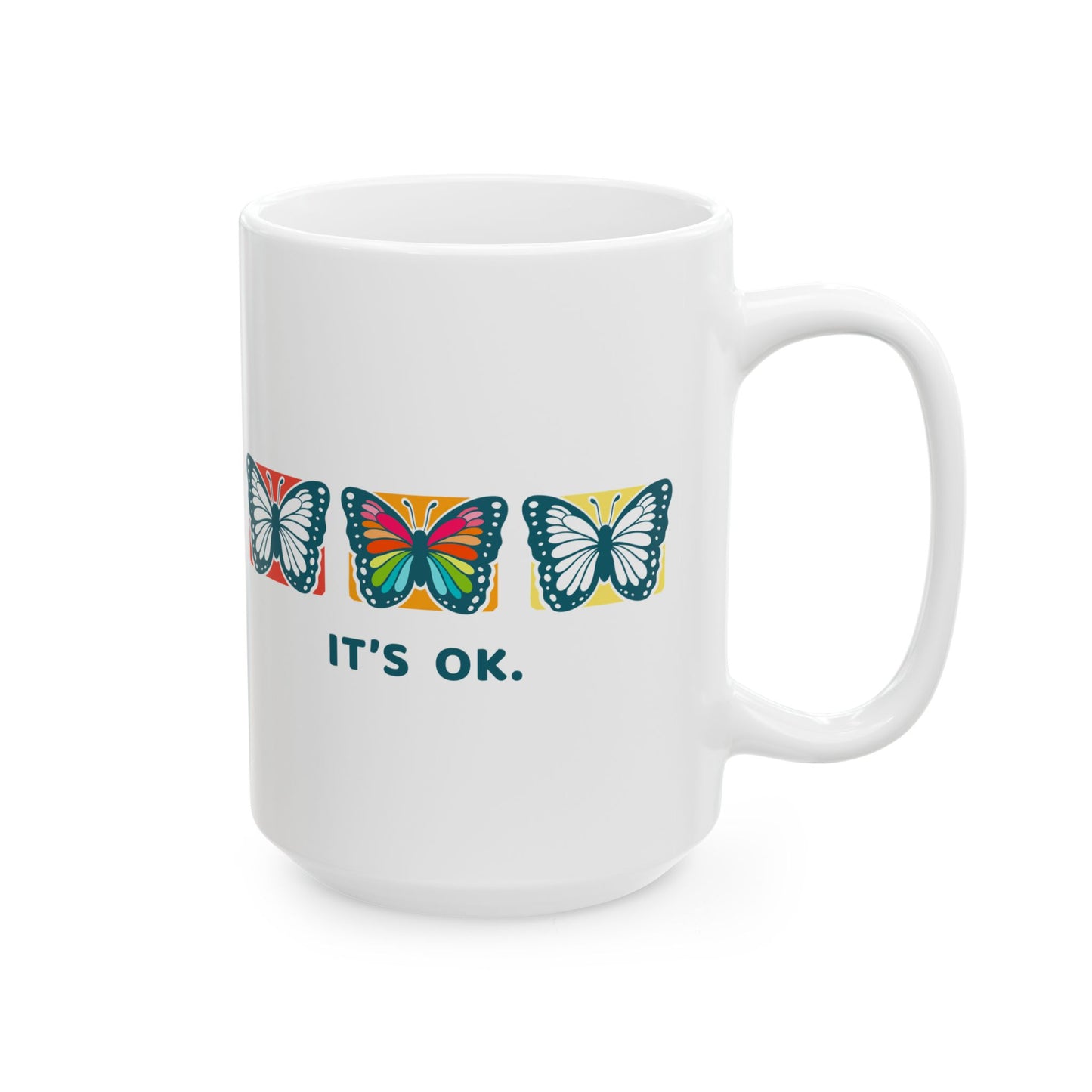 White 15oz mug with colorful butterfly design and 'it's ok' text on a white background