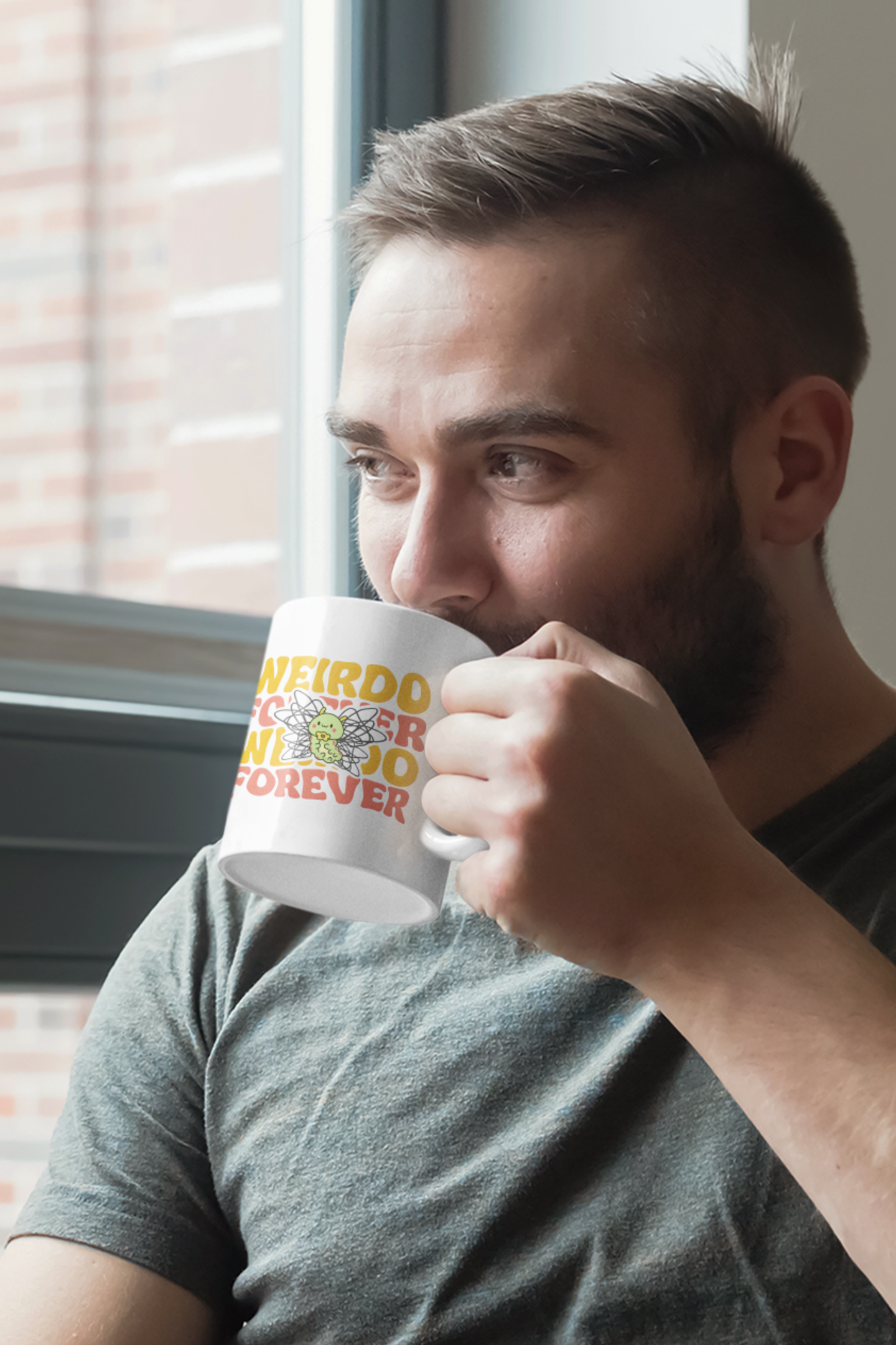 11 oz mug mockup featuring a bearded male model at a table