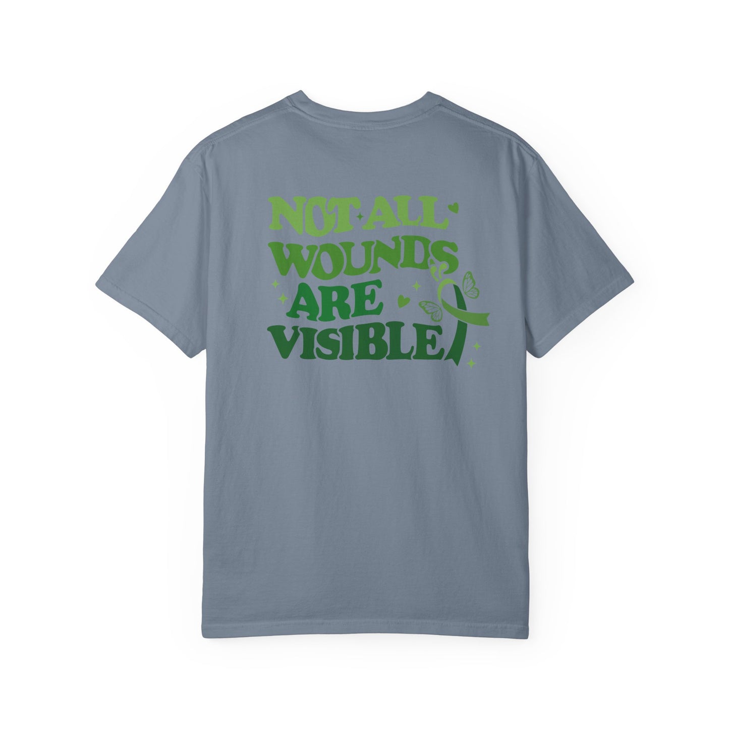 Back view of a blue mental health awareness t-shirt featuring large green text reading “Not All Wounds Are Visible” with butterfly and green ribbon artwork.
