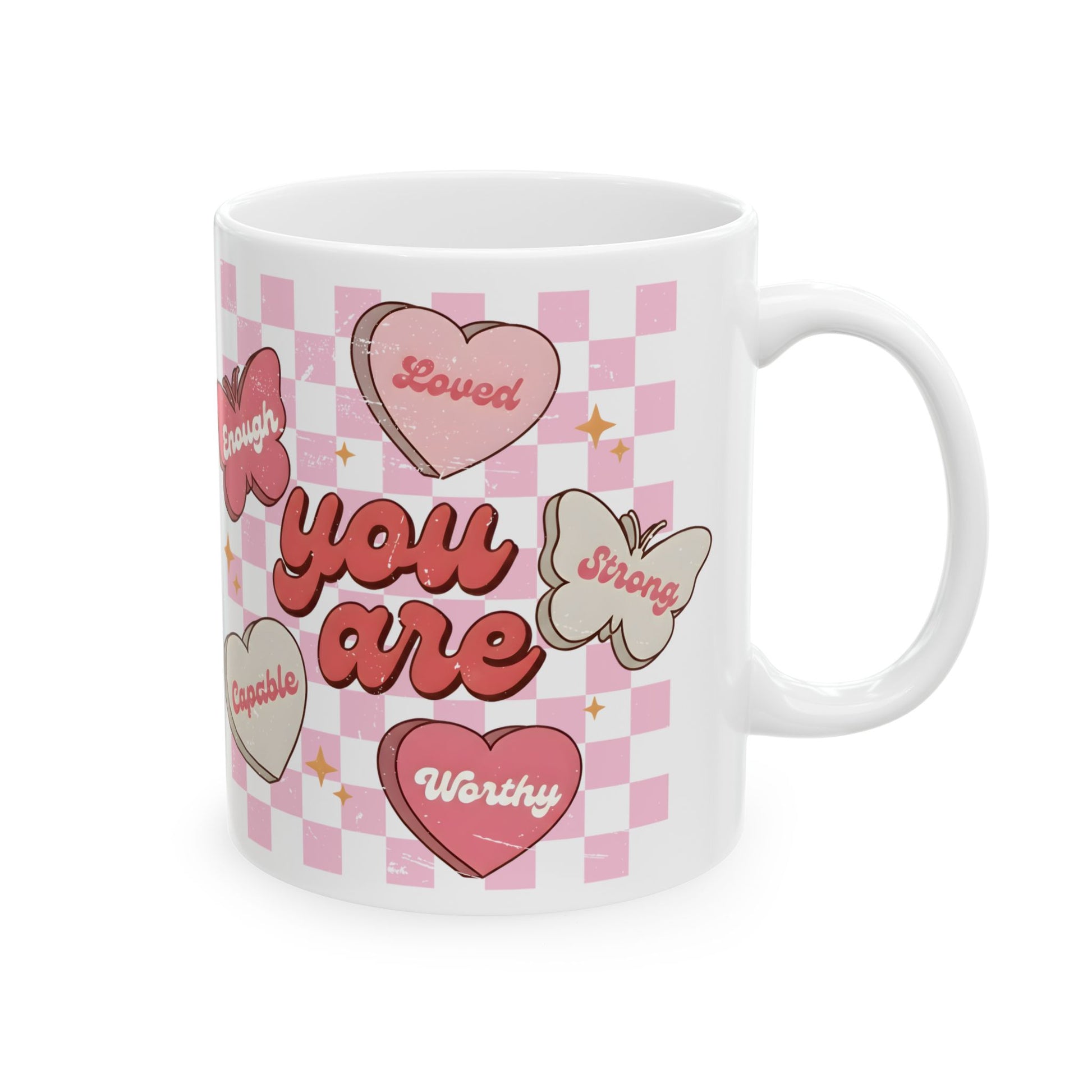 Butterfly affirmation coffee mug featuring the message “You Are Loved, Strong, Worthy, Capable, Enough” on a pink checkered background