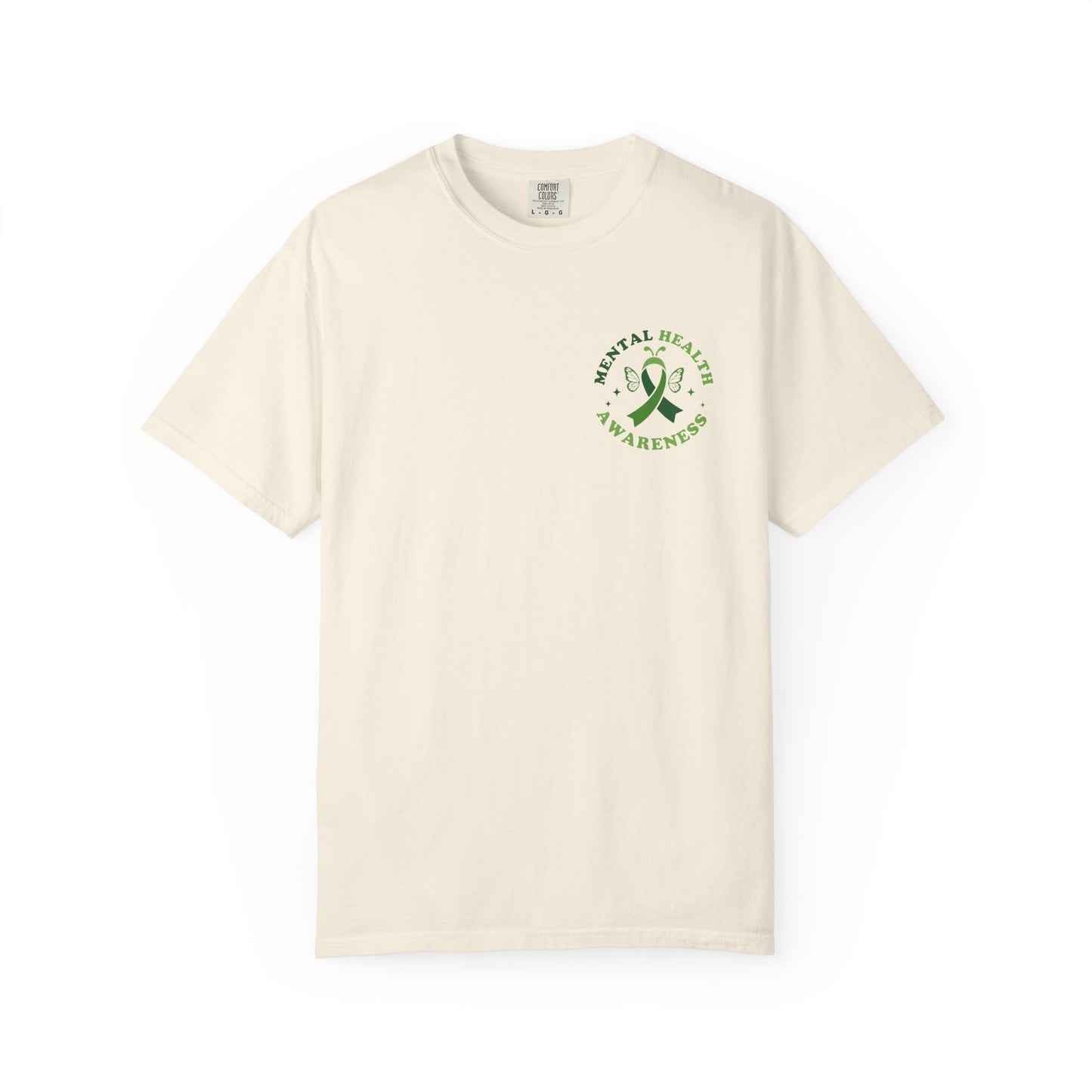 Cream garment-dyed mental health awareness t-shirt with a small green ribbon and butterfly chest graphic reading “Mental Health Awareness.”