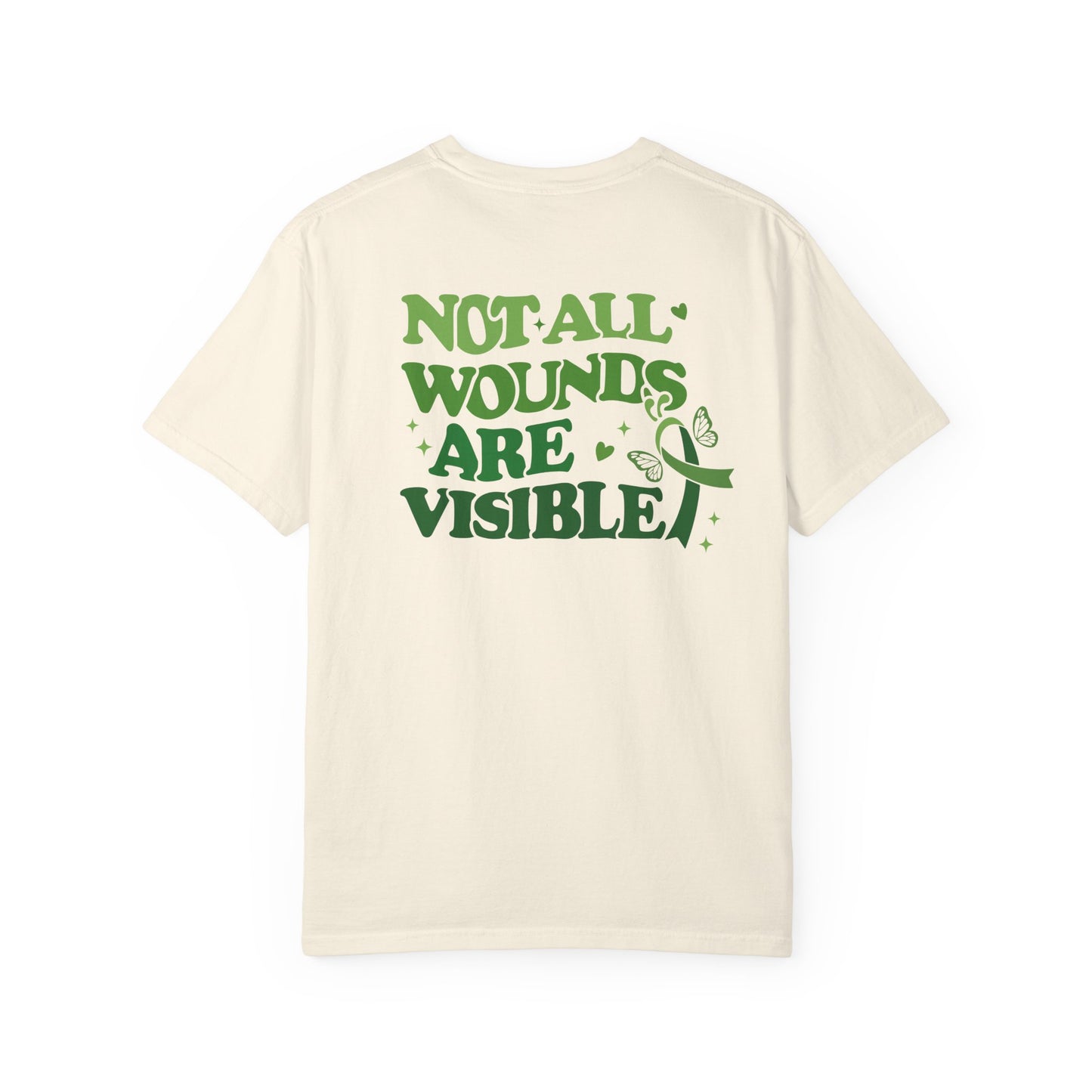 Back view of a cream mental health awareness t-shirt featuring large green text reading “Not All Wounds Are Visible” with butterfly and green ribbon artwork.