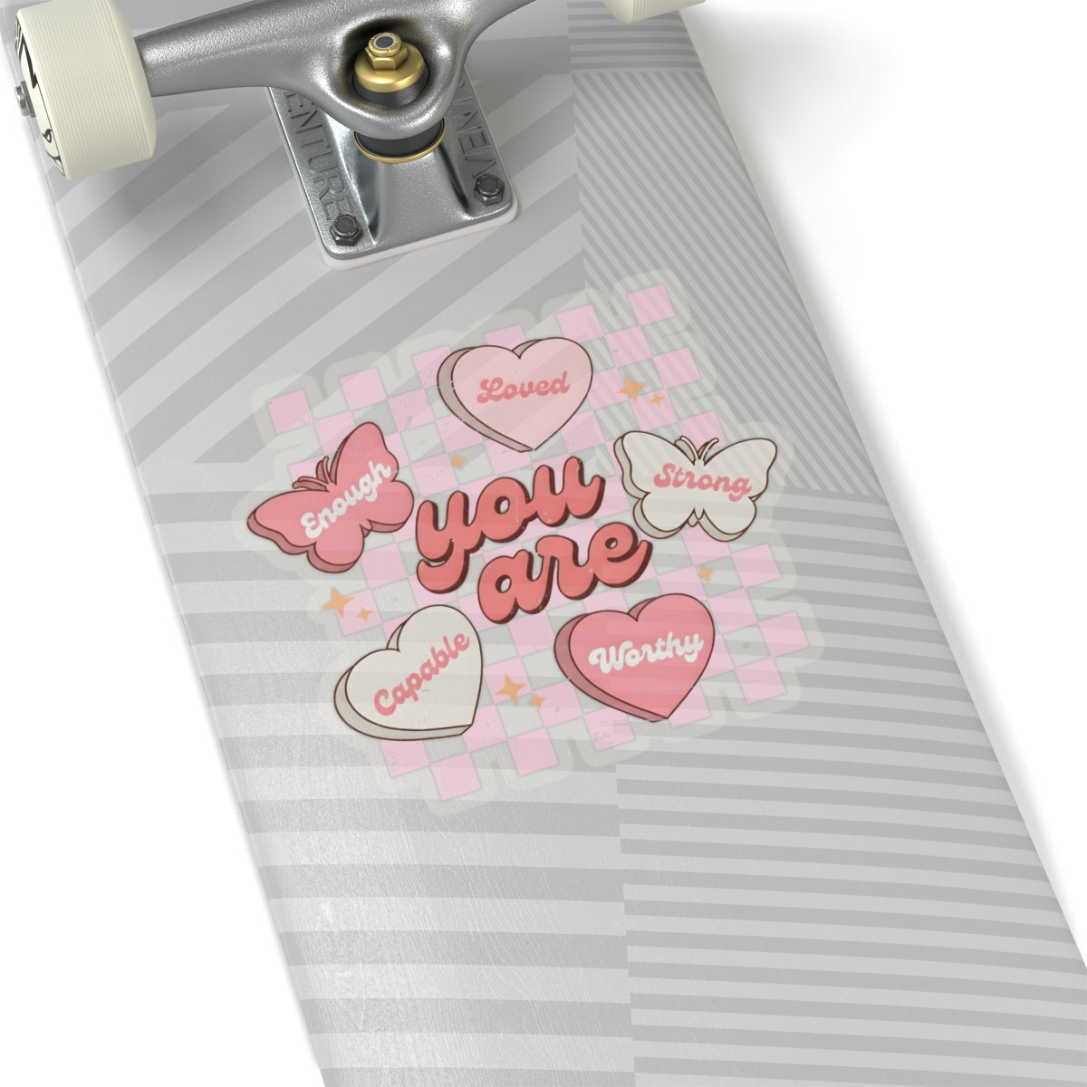 Butterfly affirmation sticker applied to skateboard on a white background