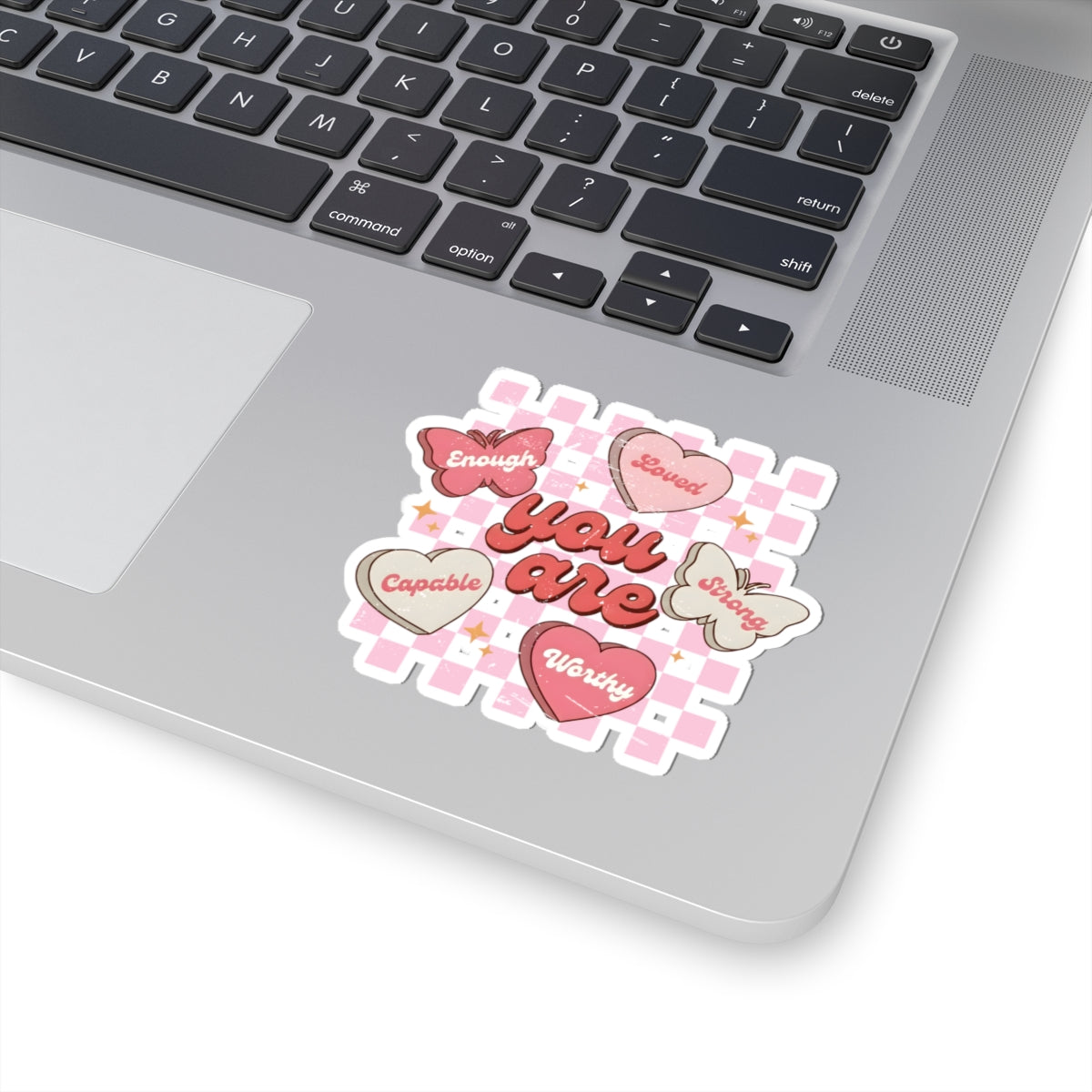 Butterfly affirmation sticker on laptop featuring hearts and motivational self love message on a white surface