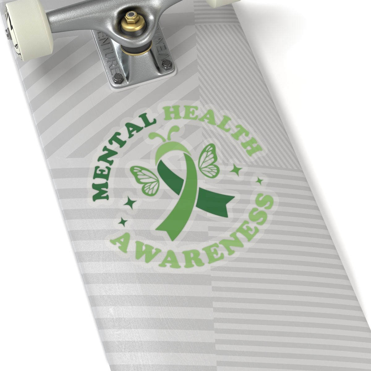 Transparent mental health awareness butterfly sticker with green ribbon design placed on a skateboard deck.