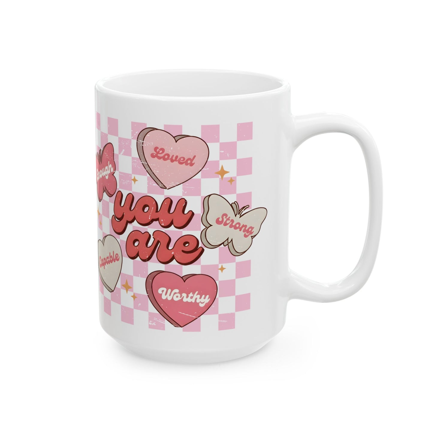 Side view of a butterfly heart affirmation mug with the message “You Are Loved, Strong, Worthy, Capable, Enough” on a white ceramic coffee mug 
