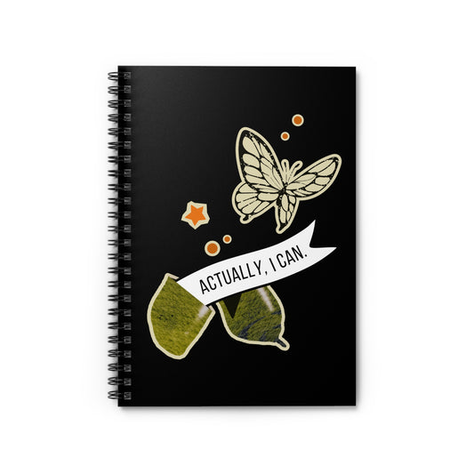 notebook with butterfly design and 'actually, i can.' text on a black background