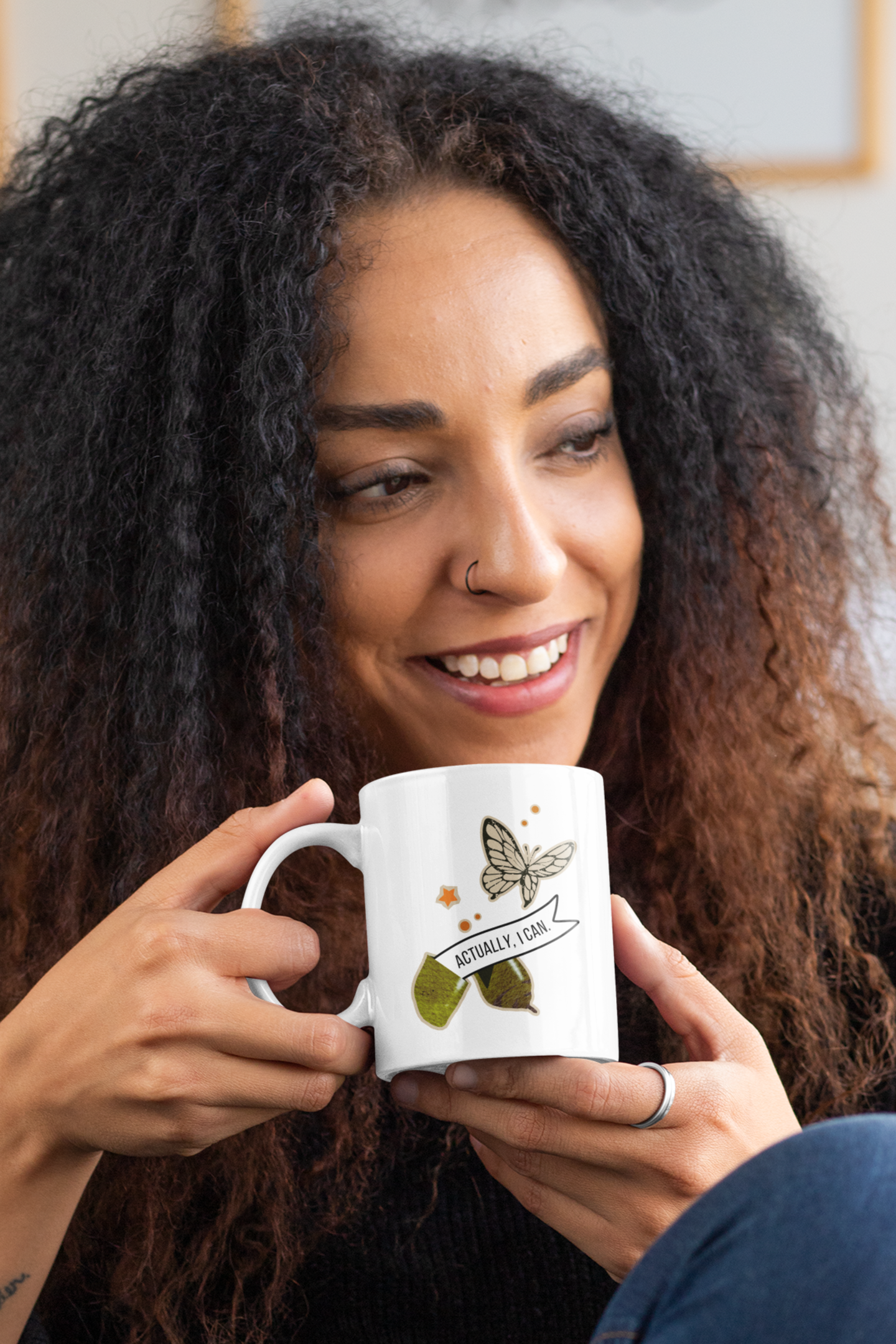 mockup of a curly-haired female model with an 11oz mug in her hands