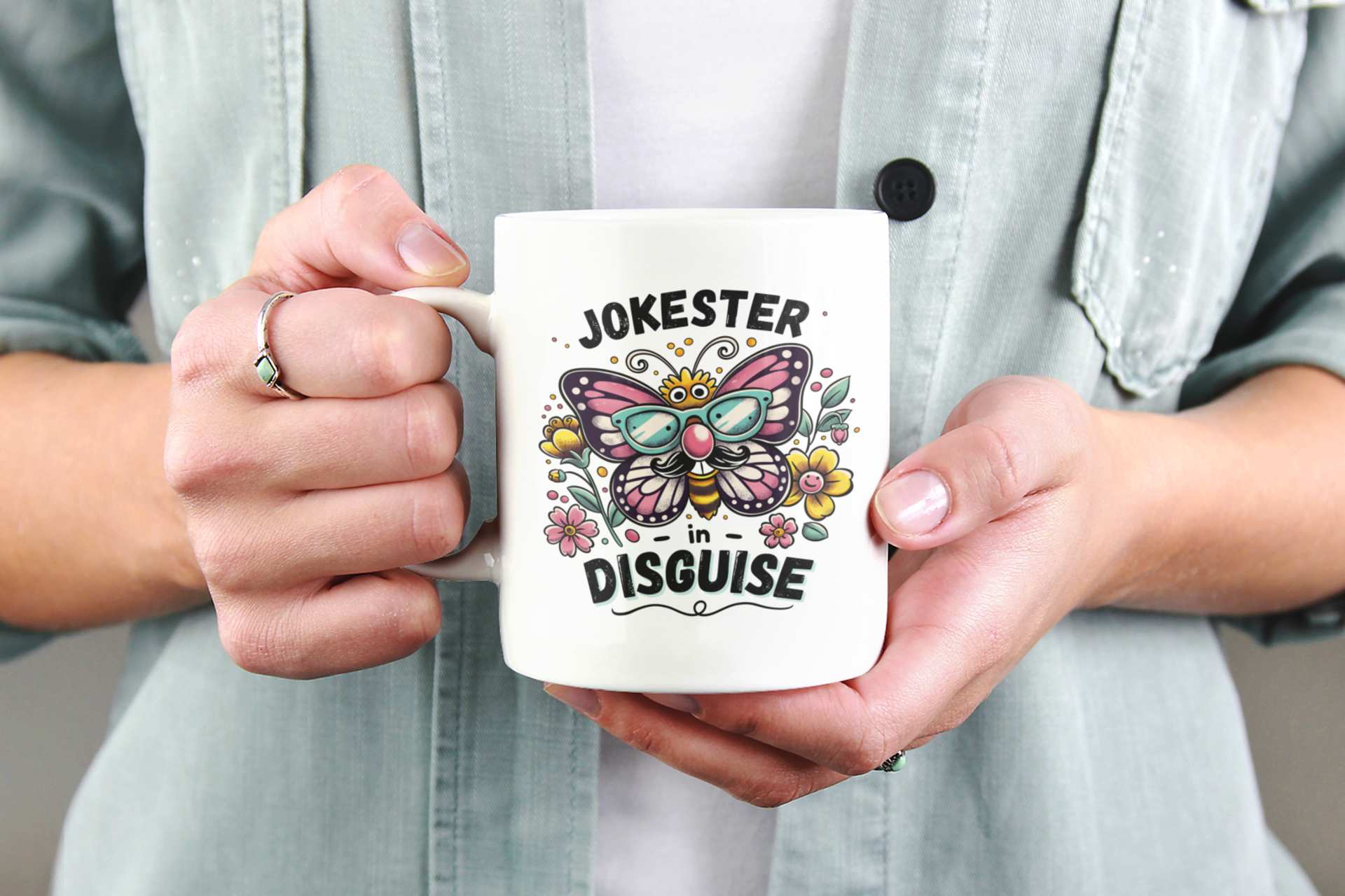 hands holding an 11 oz funny butterfly prank cup
