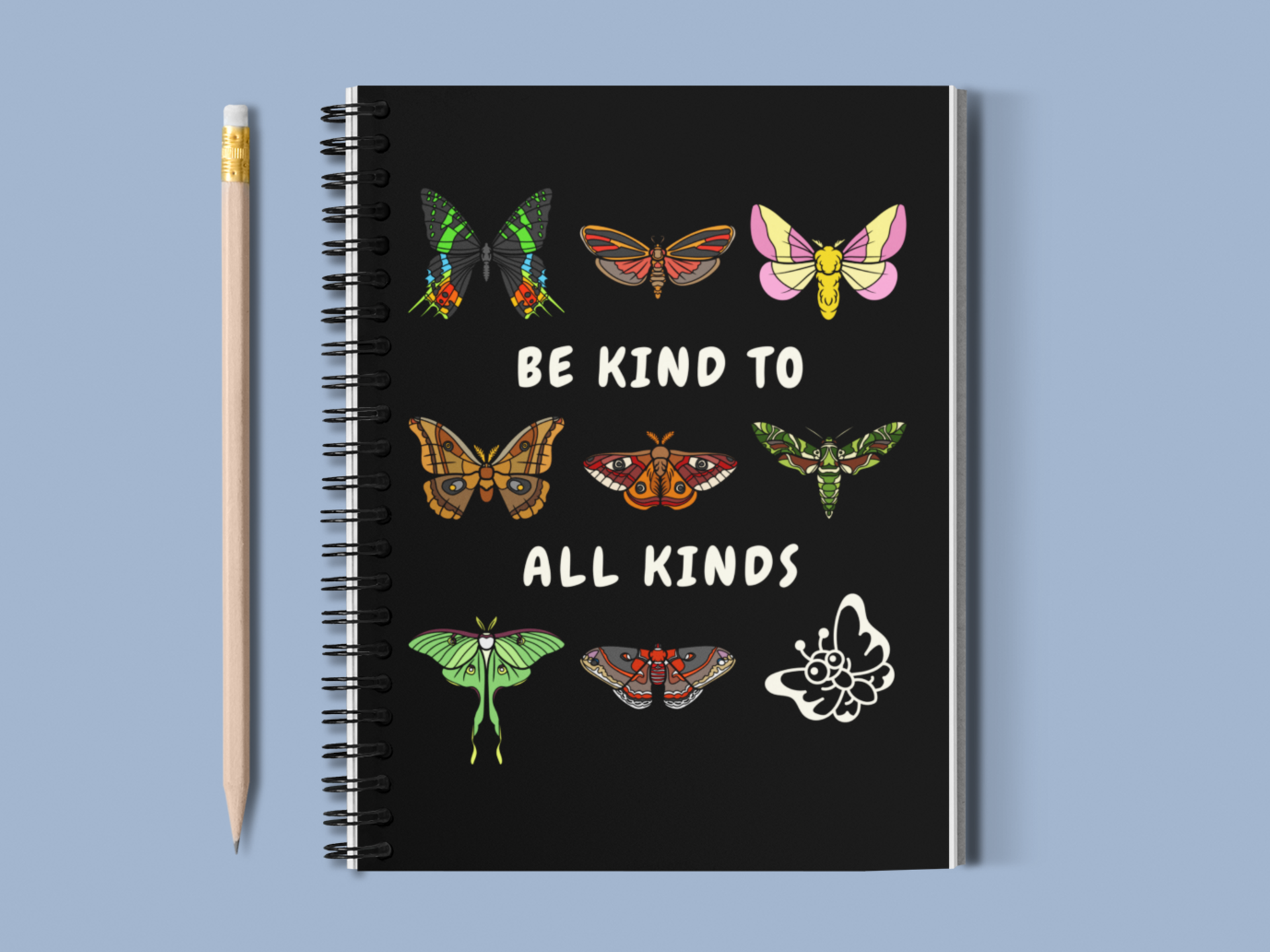 'be kind to all kinds' notebook with pencil on a blue background