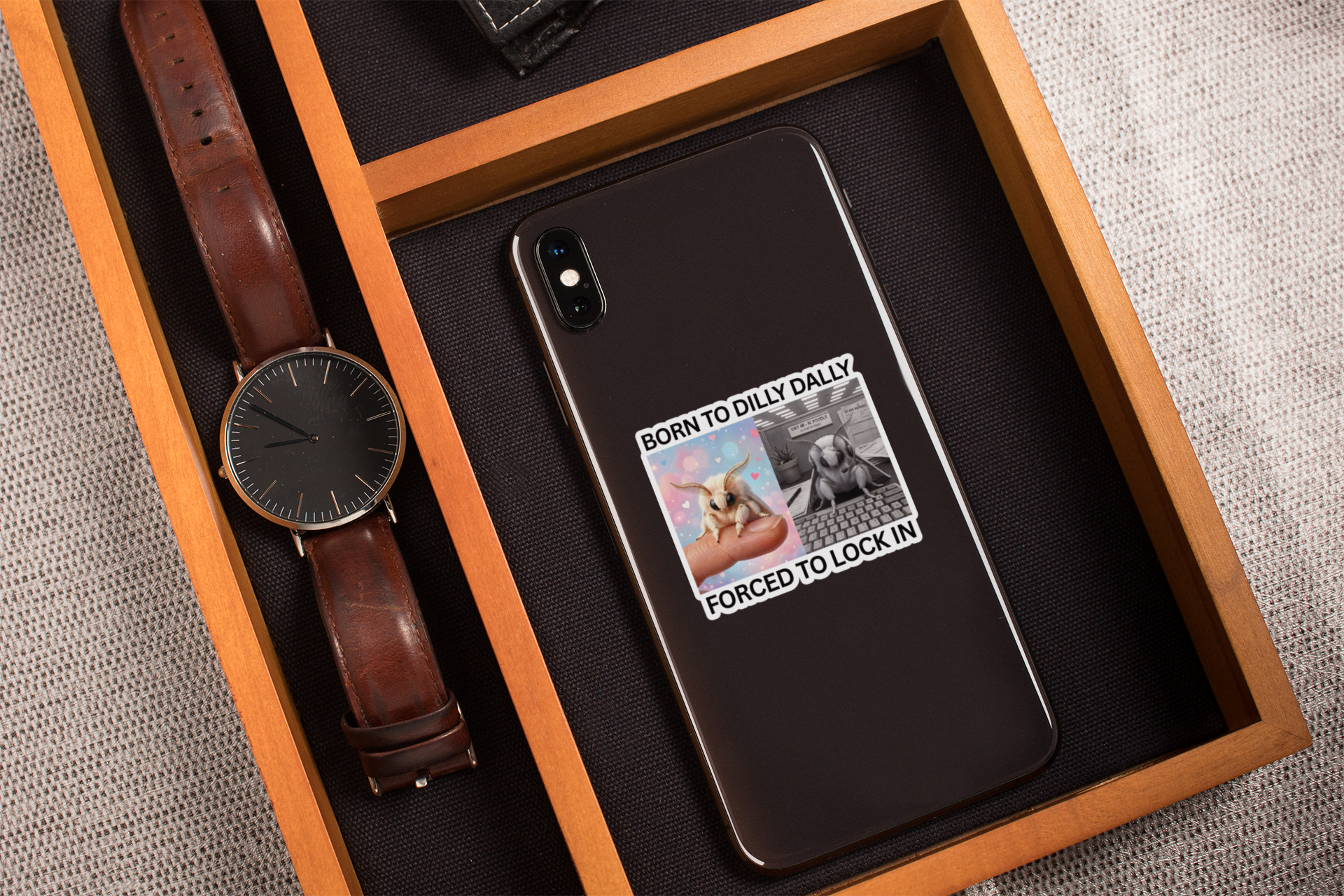 Funny moth meme sticker on smartphone case showing Born to Dilly Dally quote on a wooden box with a watch