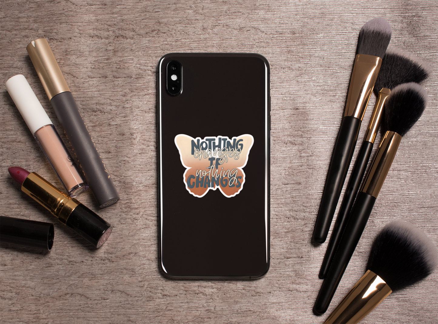 Phone case with Nothing Changes If Nothing Changes butterfly sticker on a wooden surface with makeup items