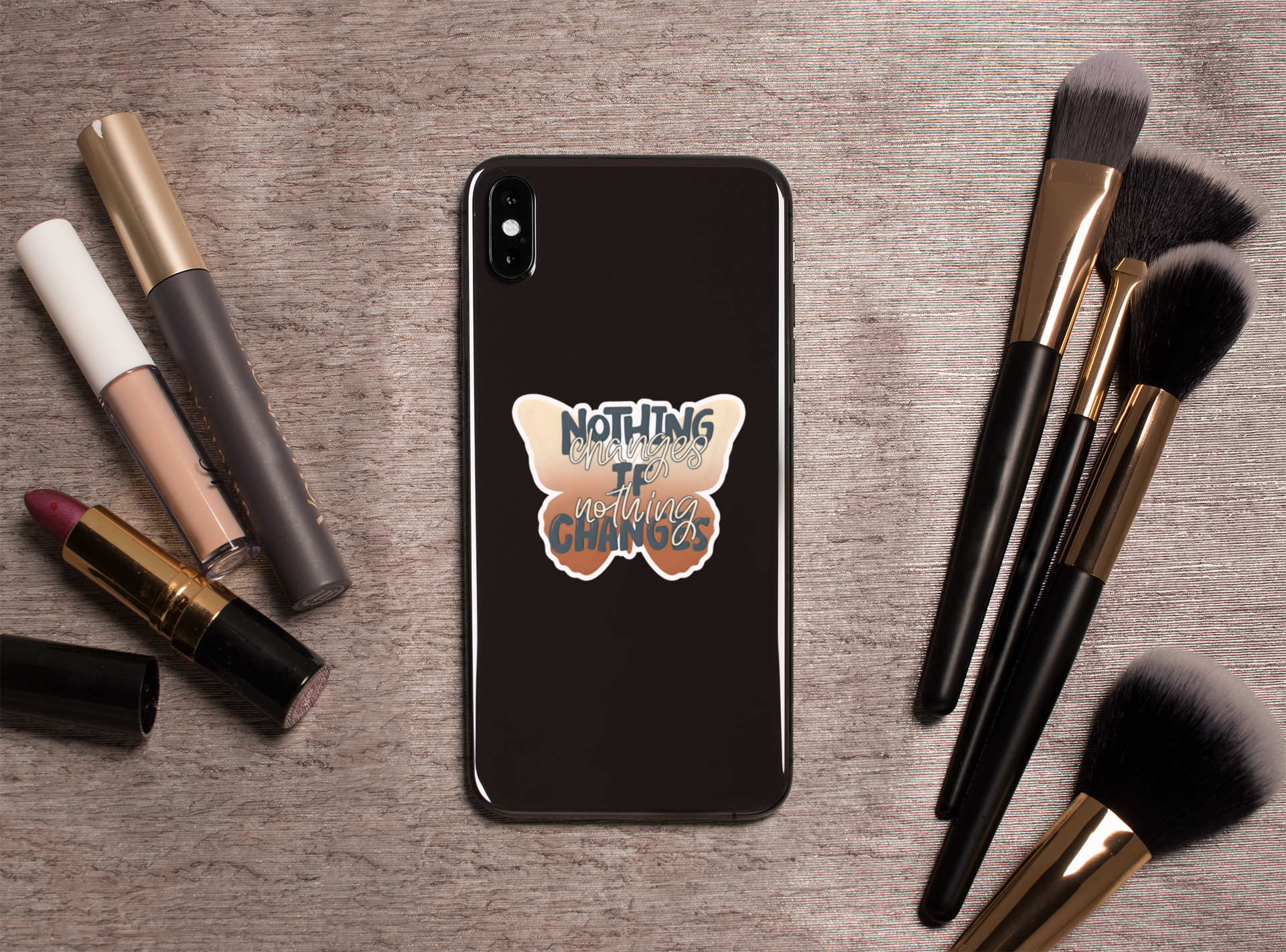 Phone case with Nothing Changes If Nothing Changes butterfly sticker on a wooden surface with makeup items