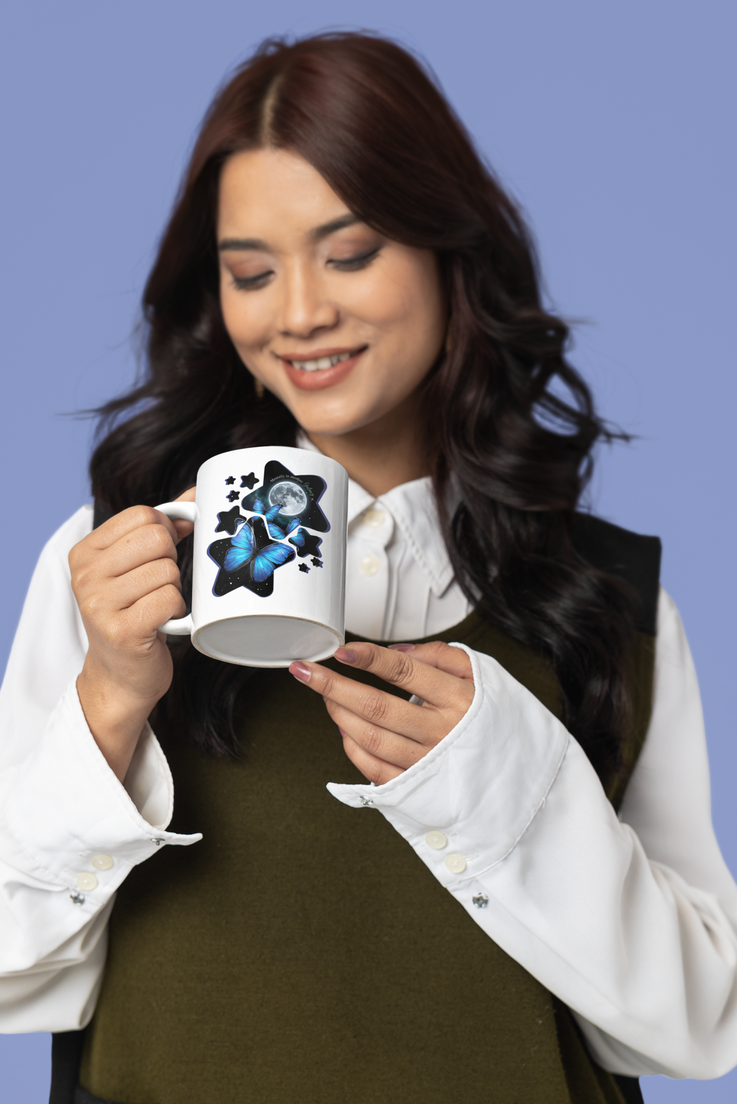 Woman holding blue morpho butterfly moon and stars galaxy mug against a purple background