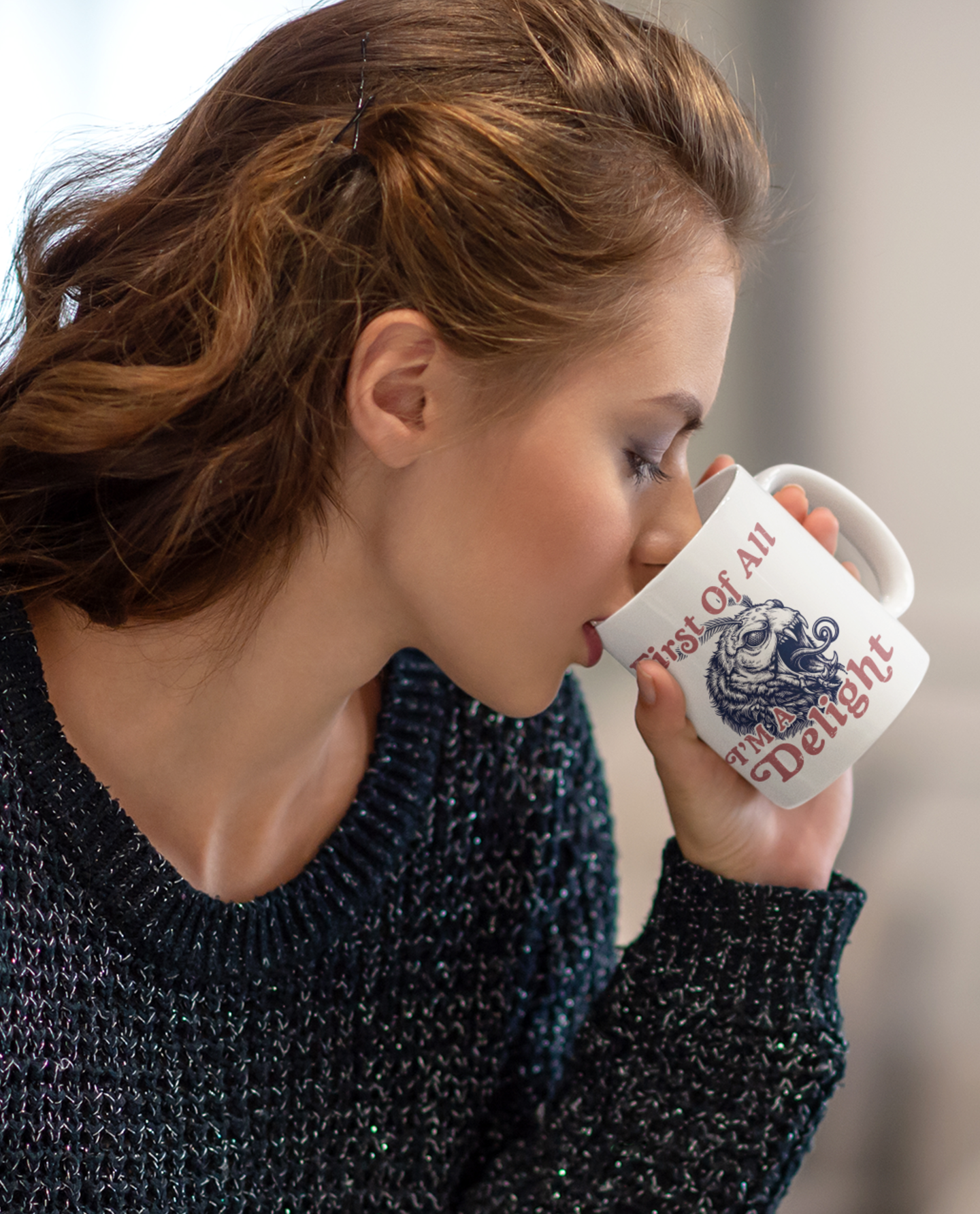 Woman drinking from a white sarcastic moth mug with retro lettering and a monster moth illustration.