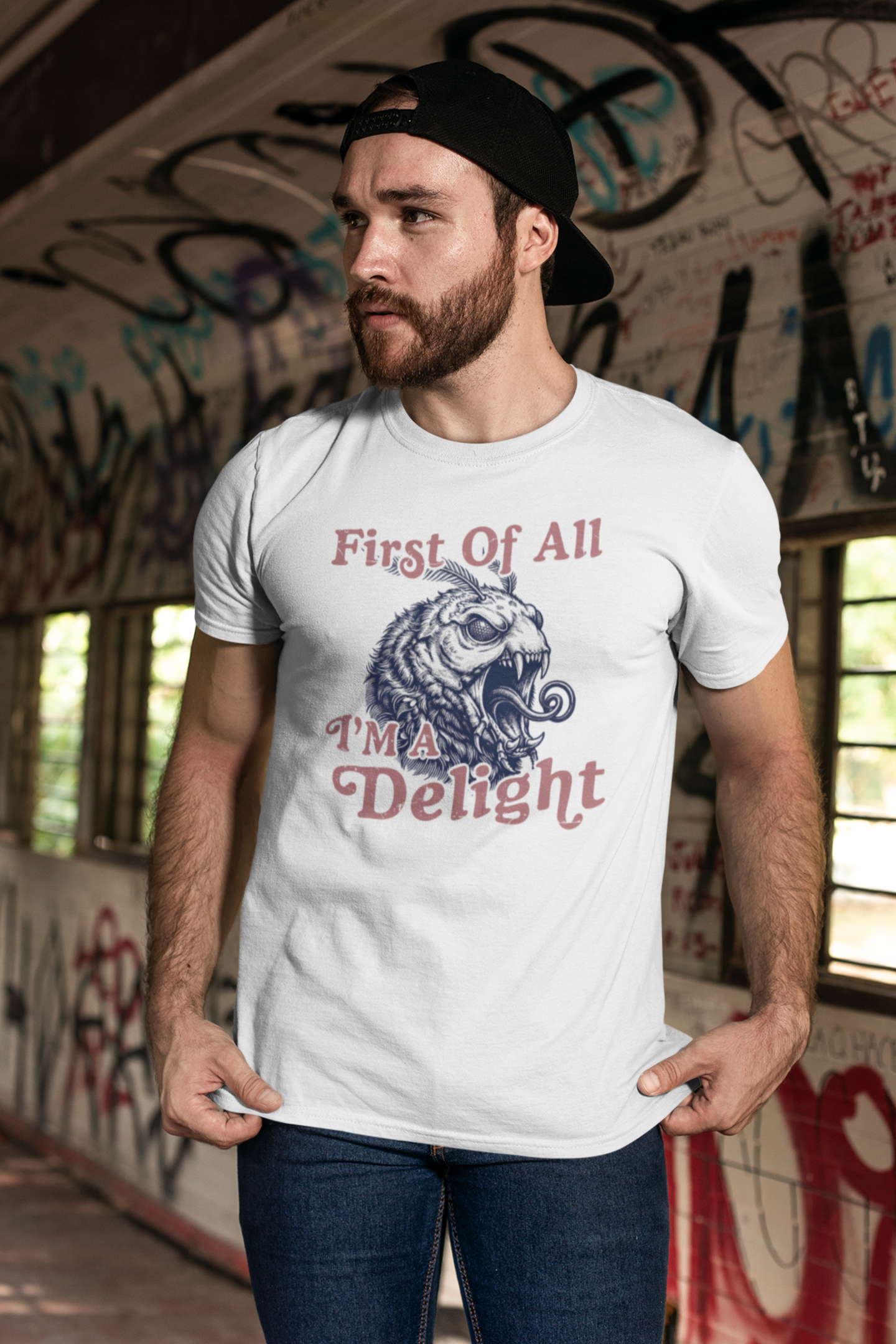 Man modeling a white First Of All I’m a Delight monster moth graphic t-shirt in an urban setting.