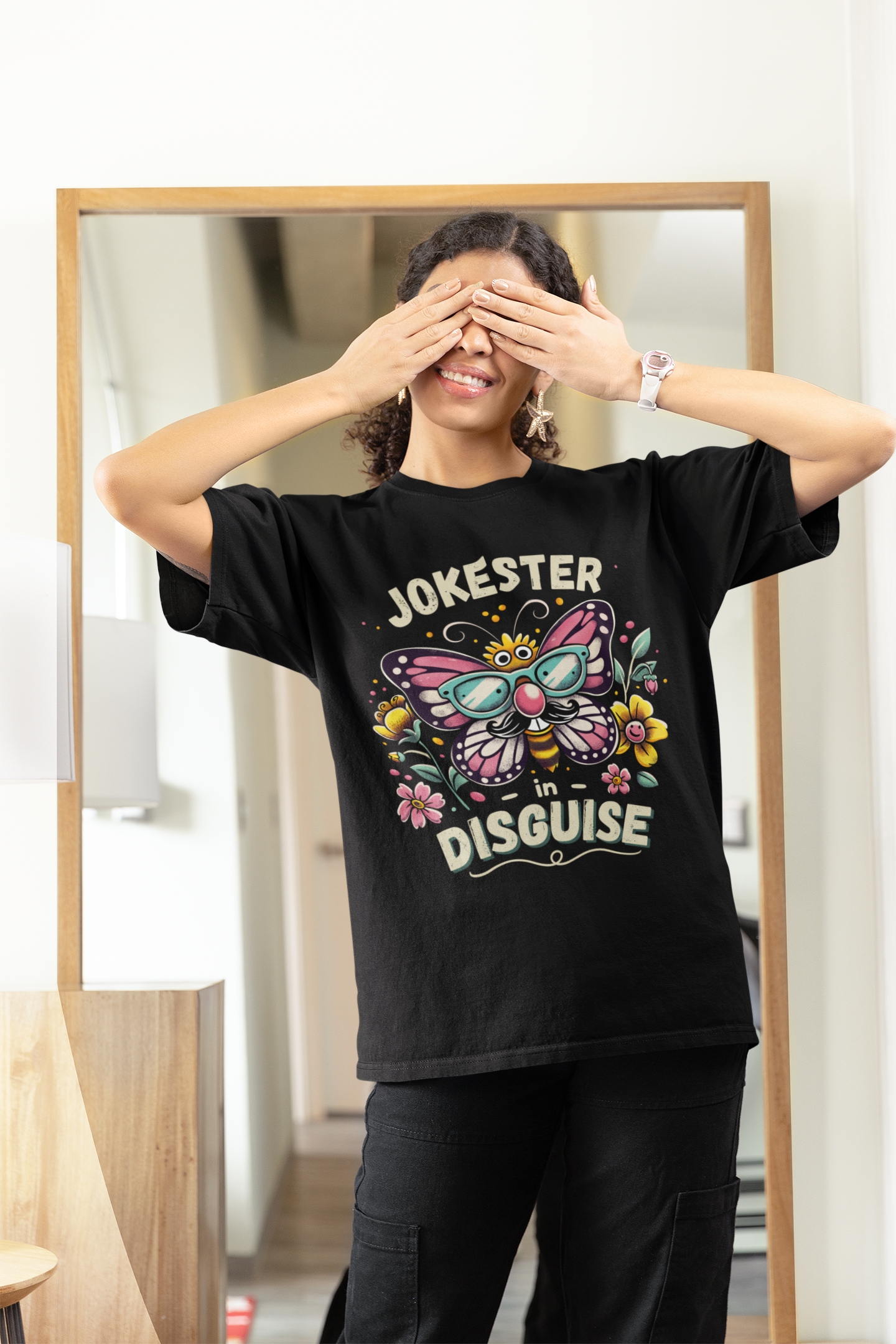 woman covering eyes, smiling, wearing eco-friendly funny butterfly prank shirt in black—perfect April Fools motivational tee