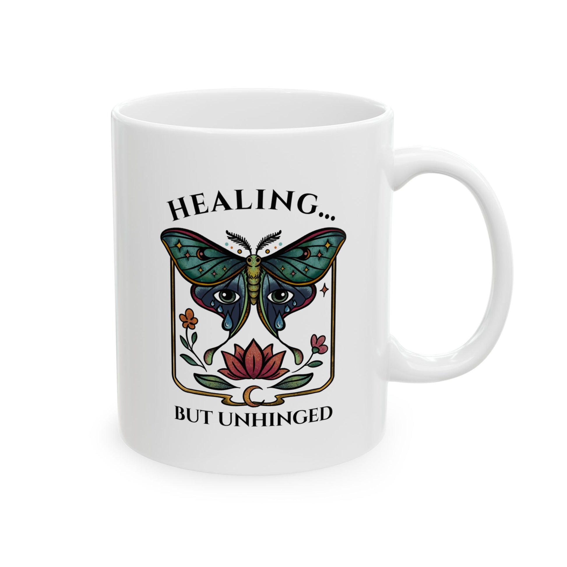 white ceramic 11oz cup with a luna moth, lotus flower, and crescent moon with a playful mental health message