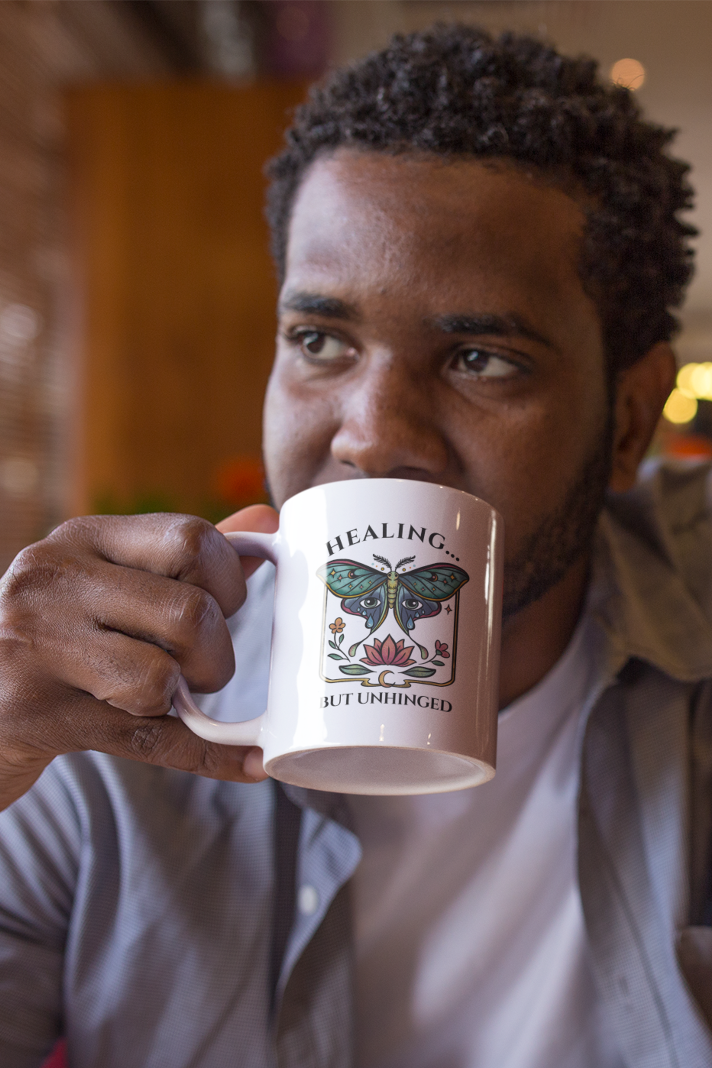 mug mockup featuring a male model drinking coffee at a diner 