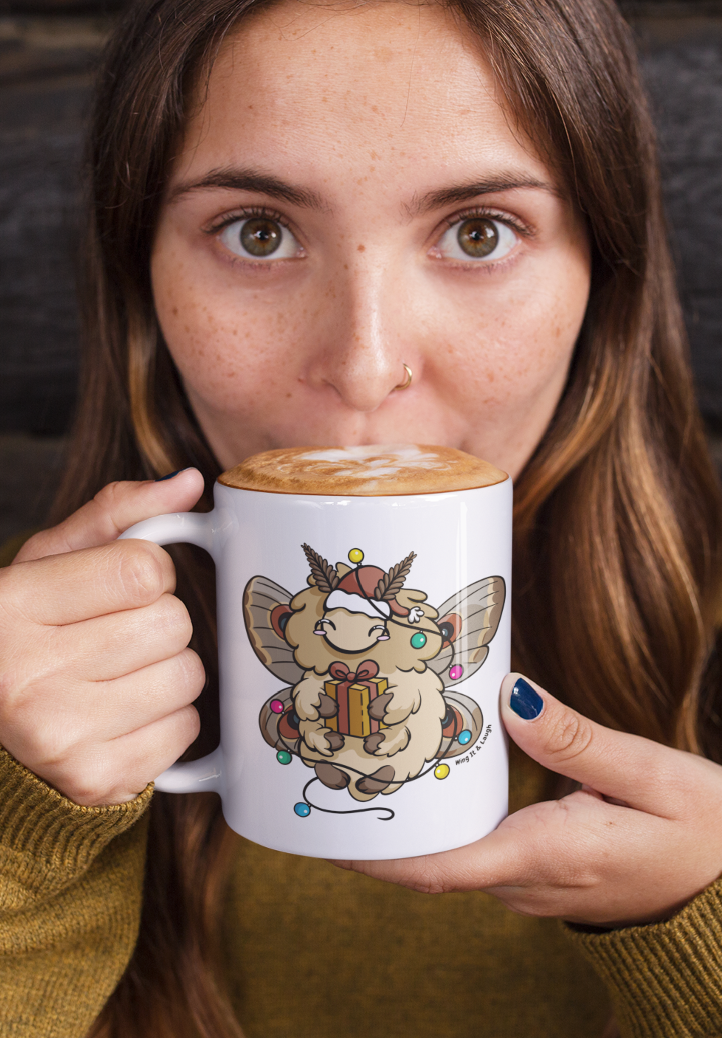 Woman drinking from a mug with a cute animal holiday moth design on it.