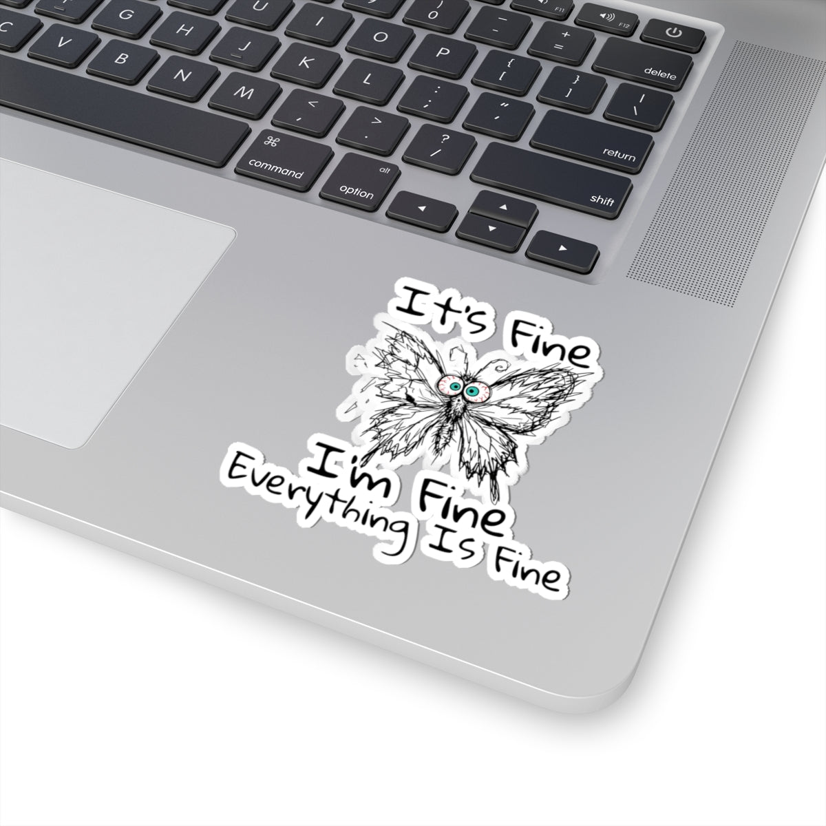 Funny anxious butterfly kiss-cut sticker on laptop with It's Fine I'm Fine Everything Is Fine quote on the palm rest area.