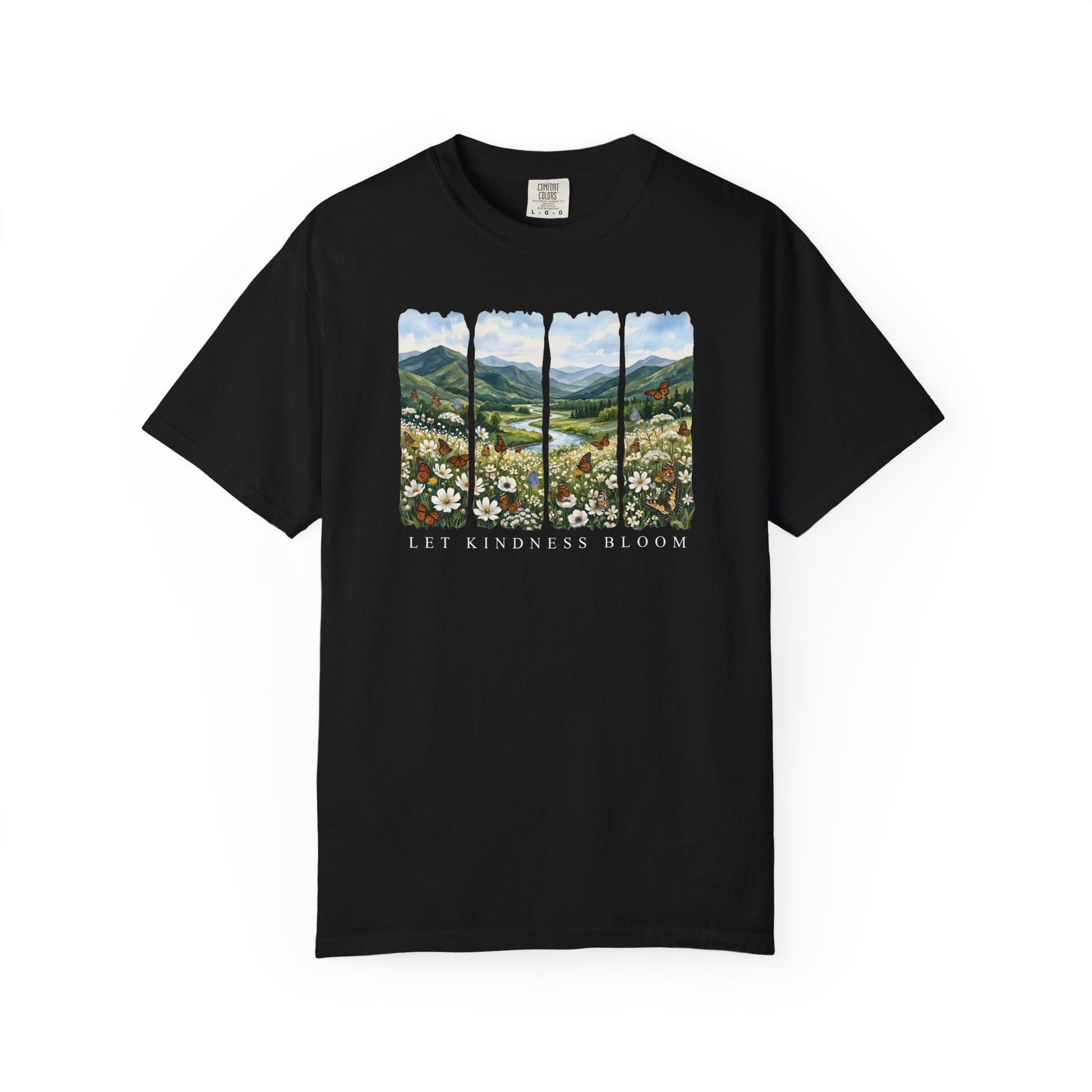 Black unisex garment-dyed t-shirt featuring a floral mountain landscape with butterflies and the phrase Let Kindness Bloom on a white background