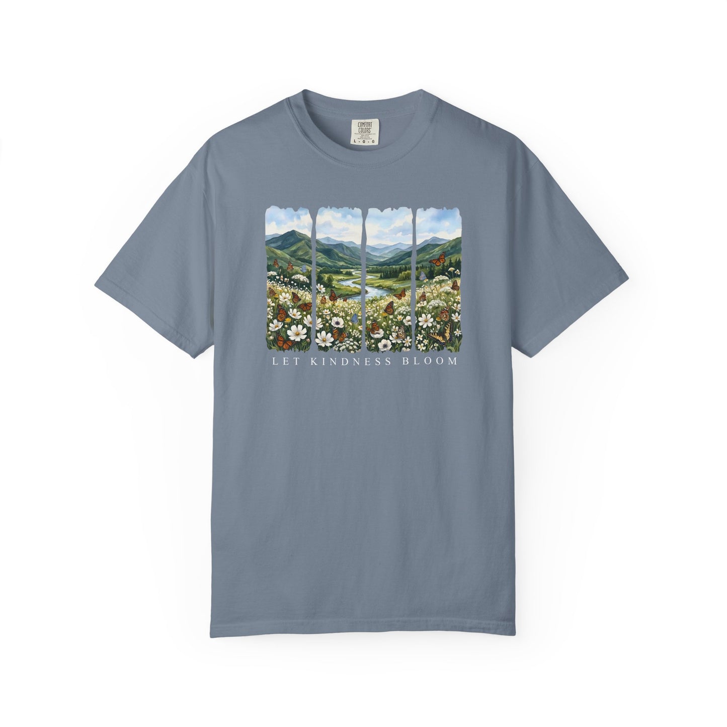 Blue Let Kindness Bloom t-shirt featuring floral butterfly landscape artwork and inspirational text on a white background