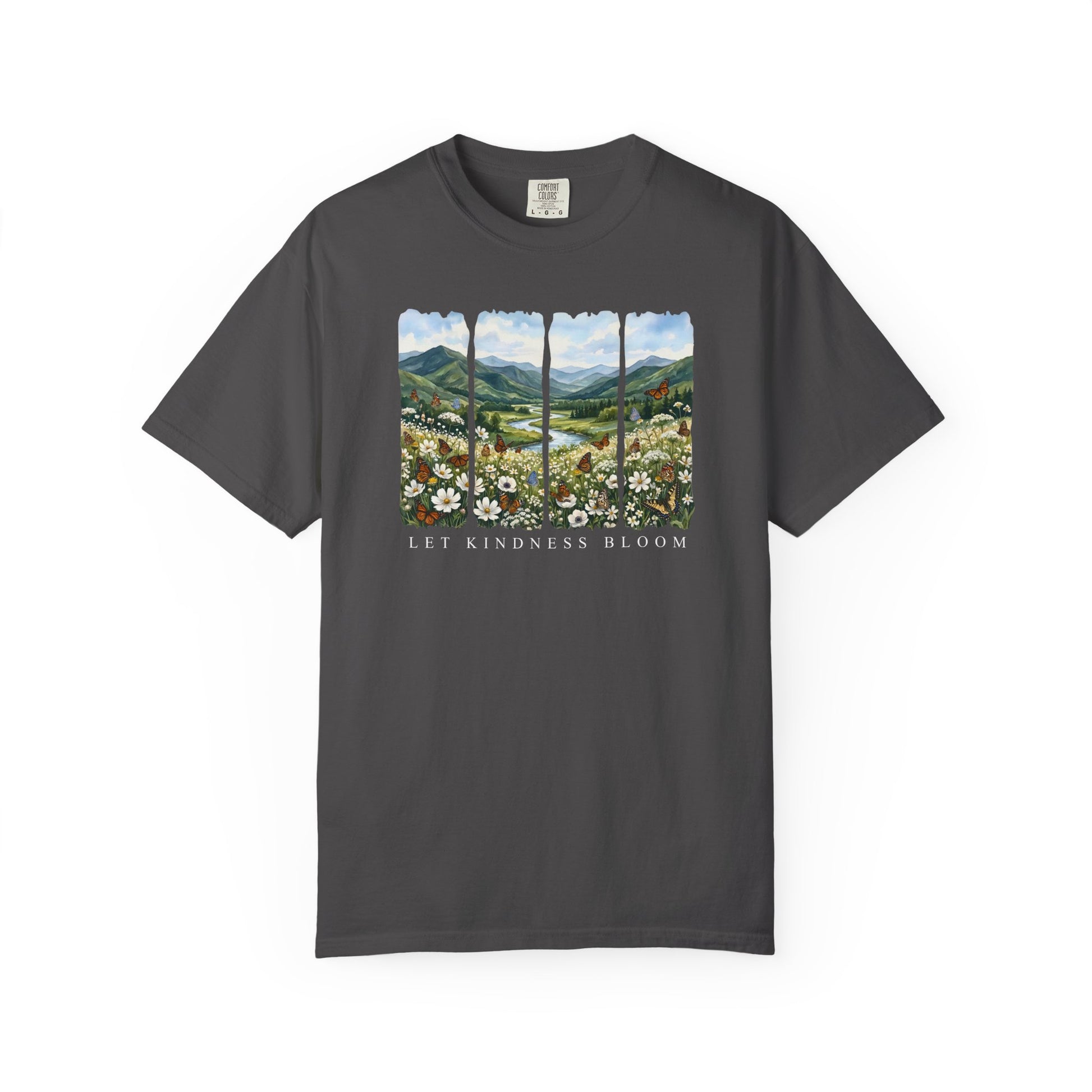 Dark gray garment-dyed Let Kindness Bloom t-shirt with floral meadow, butterflies, and mountain landscape artwork on a white background