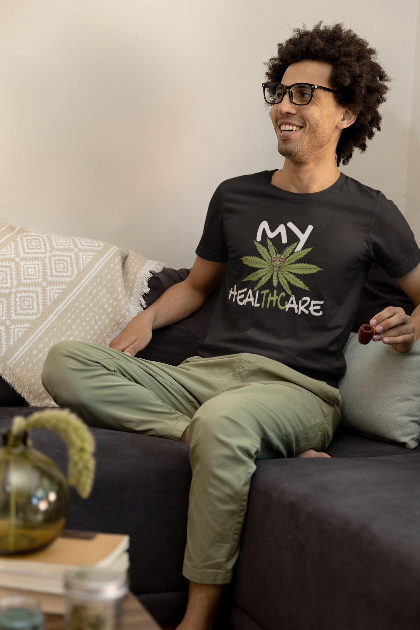 Man wearing a black My Healthcare cannabis butterfly t-shirt with a funny THC marijuana leaf design for weed lovers and 420 fans.