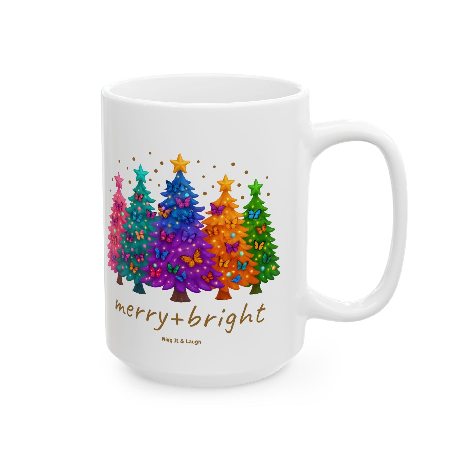 White 15oz mug with colorful Christmas trees, stars and butterflies, and 'merry + bright' text on a white background.