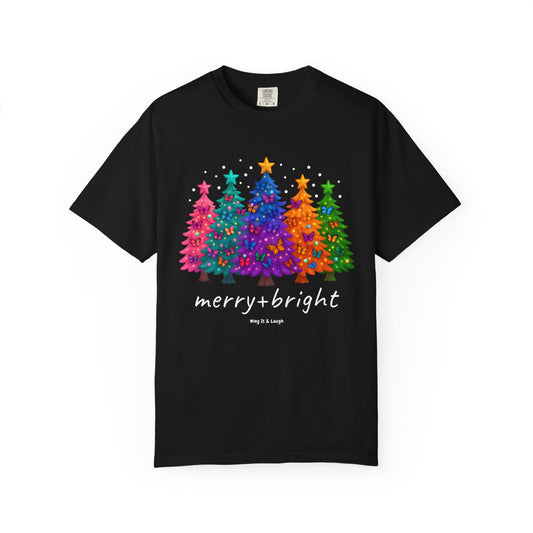 White t-shirt with colorful stars and christmas trees design and 'merry and bright' text on a white background.