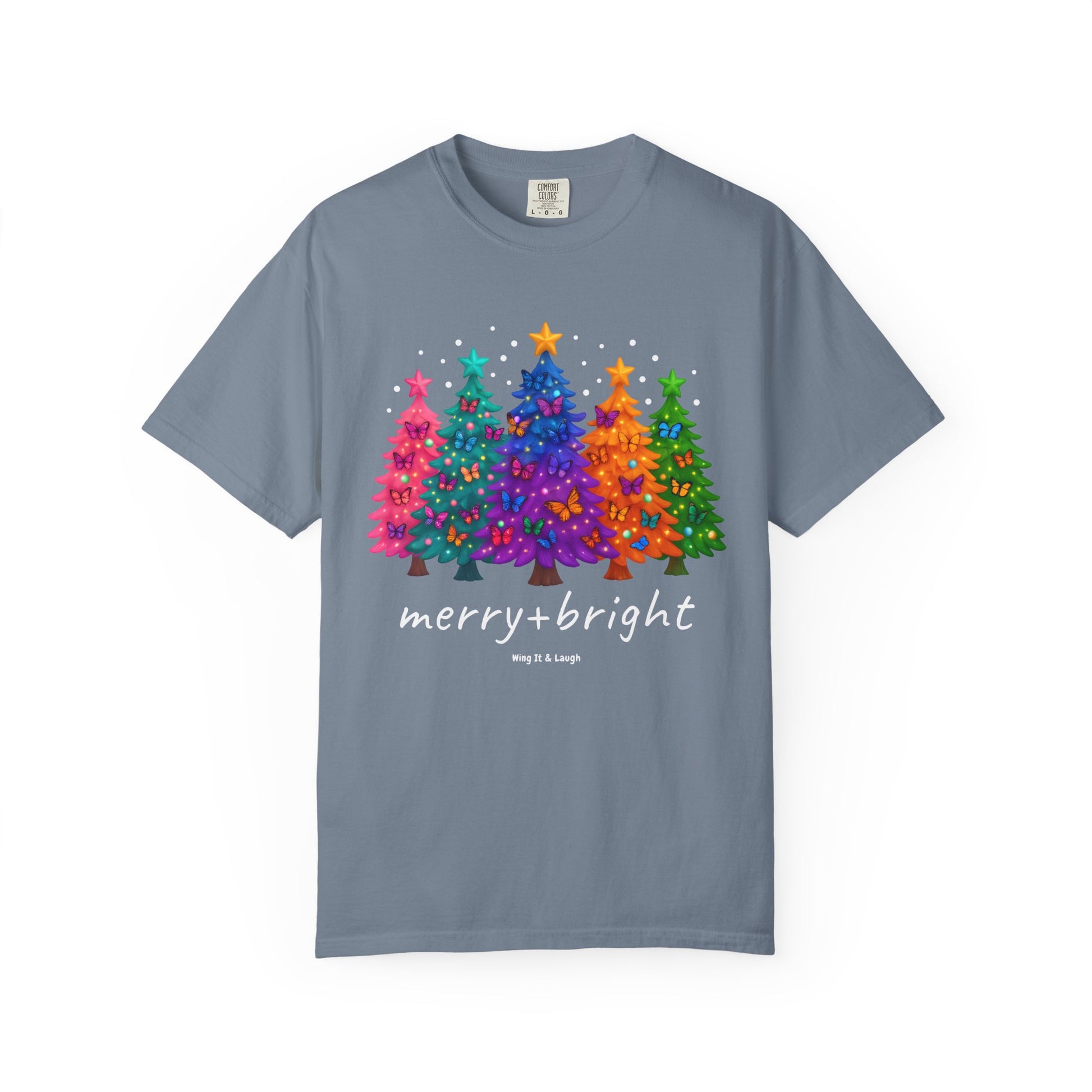 Blue t-shirt with colorful stars and christmas trees design and 'merry and bright' text on a white background.