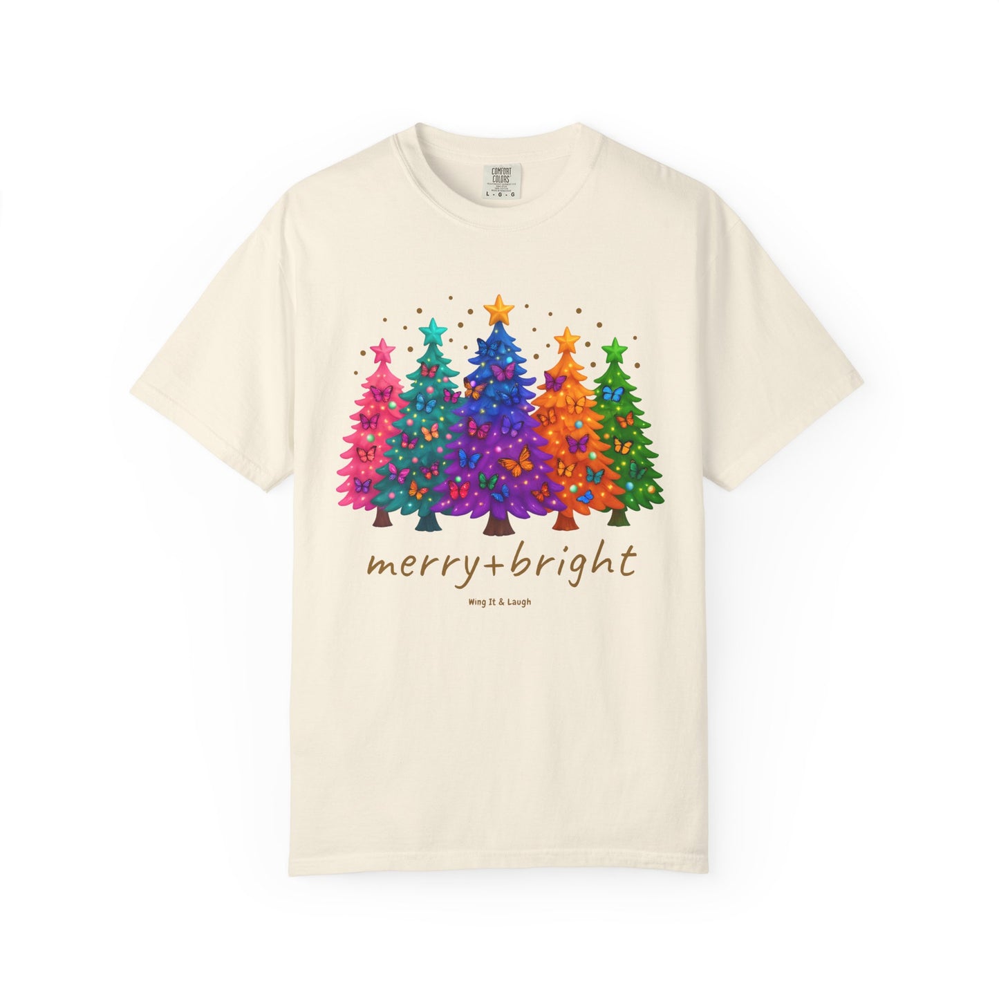 Cream t-shirt with colorful stars and christmas trees design and 'merry and bright' text on a white background.