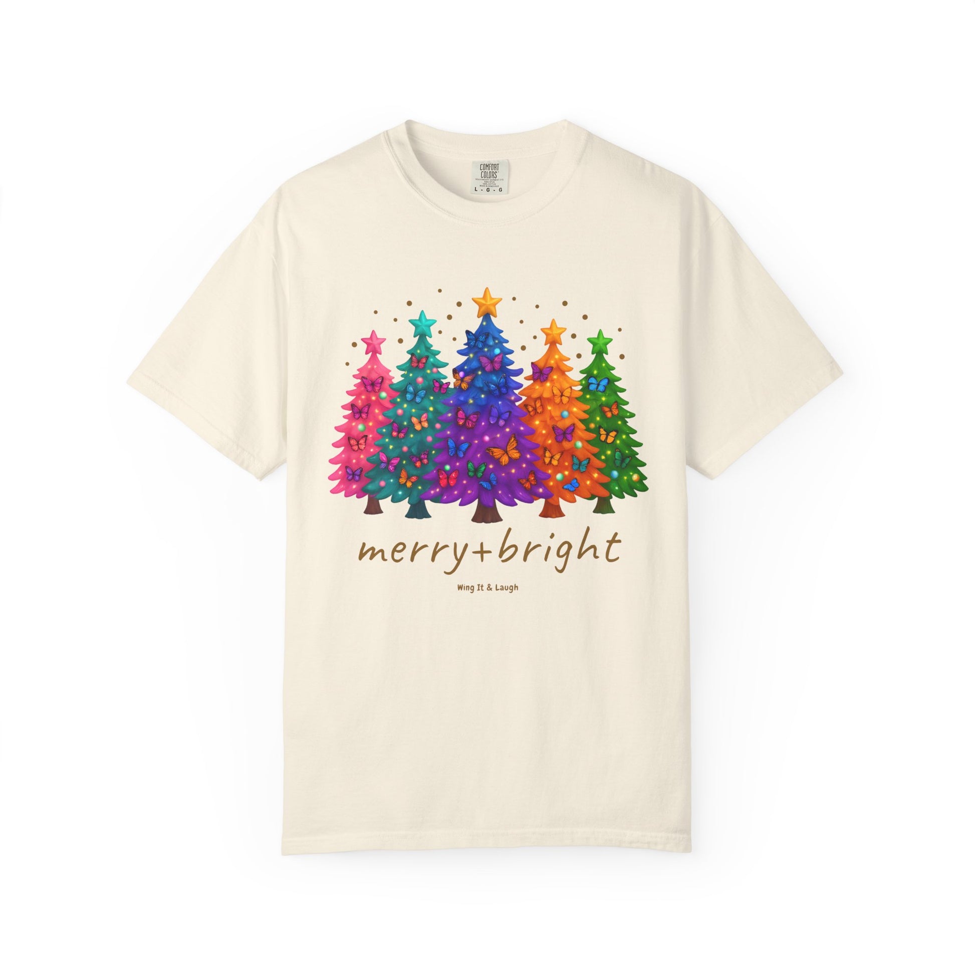 Cream t-shirt with colorful stars and christmas trees design and 'merry and bright' text on a white background.