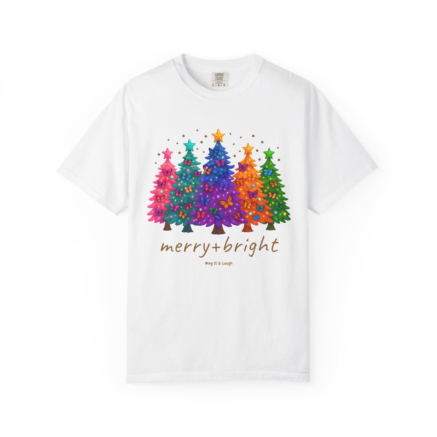 White t-shirt with colorful stars and christmas trees design and 'merry and bright' text on a white background.