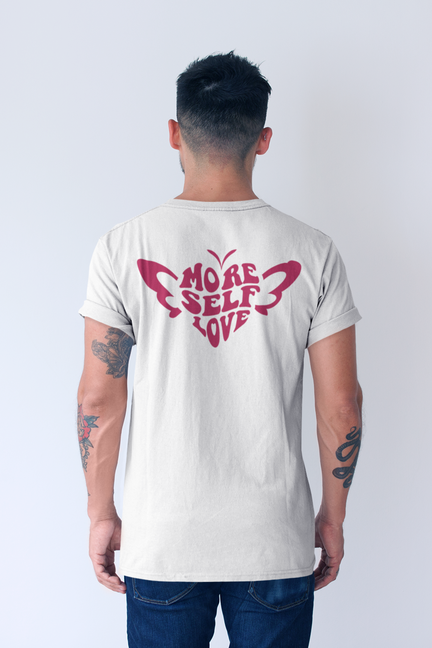 Person wearing a white butterfly heart self love valentine shirt on the back.