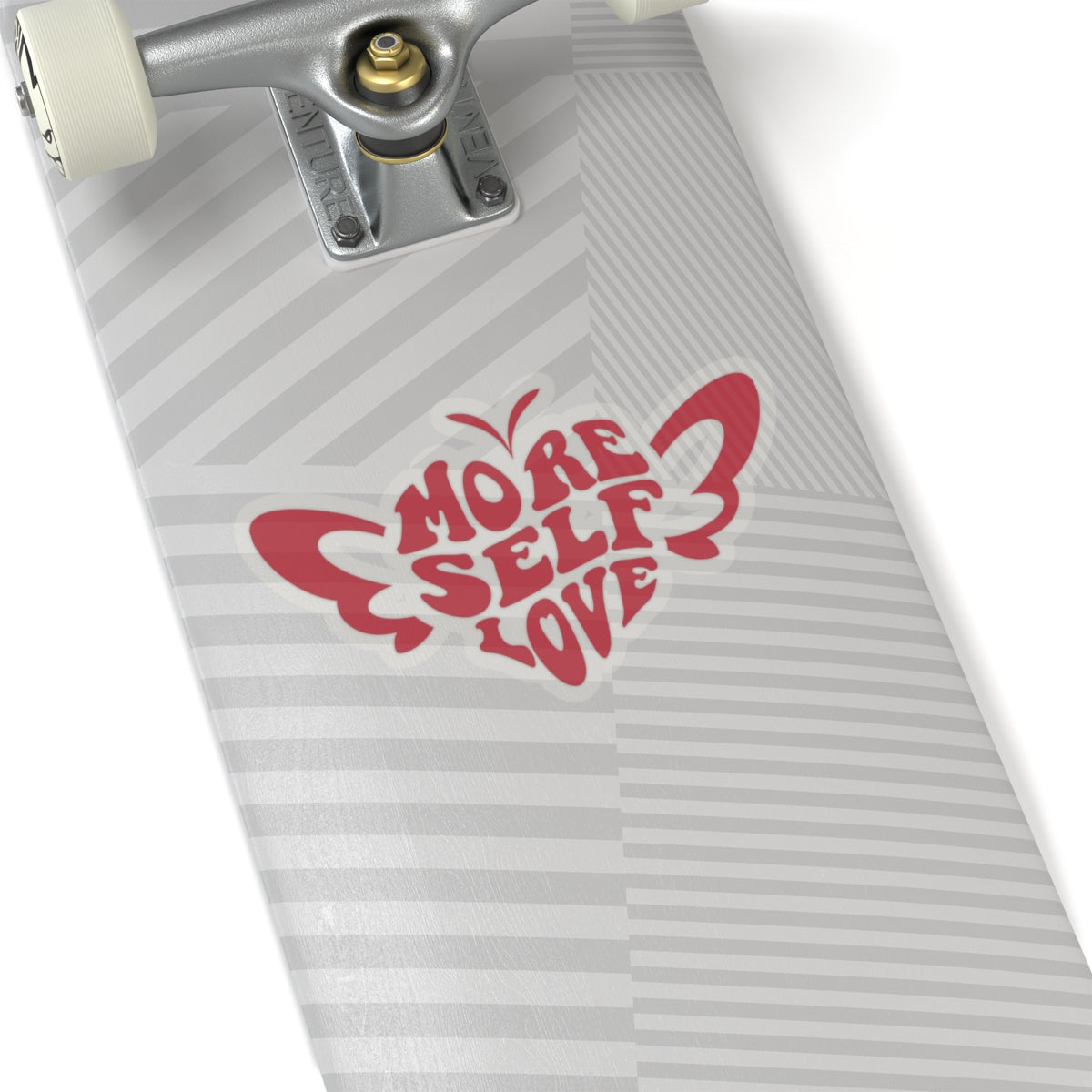 Skateboard with a More Self Love butterfly vinyl decal on a white background