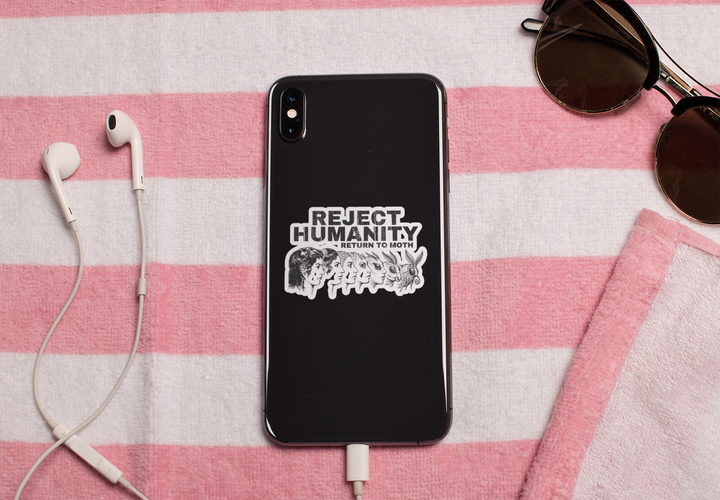 Black phone with funny insect vinyl decal reject humanity return to moth on a pink and white checkered background with earphones and sunglasses.