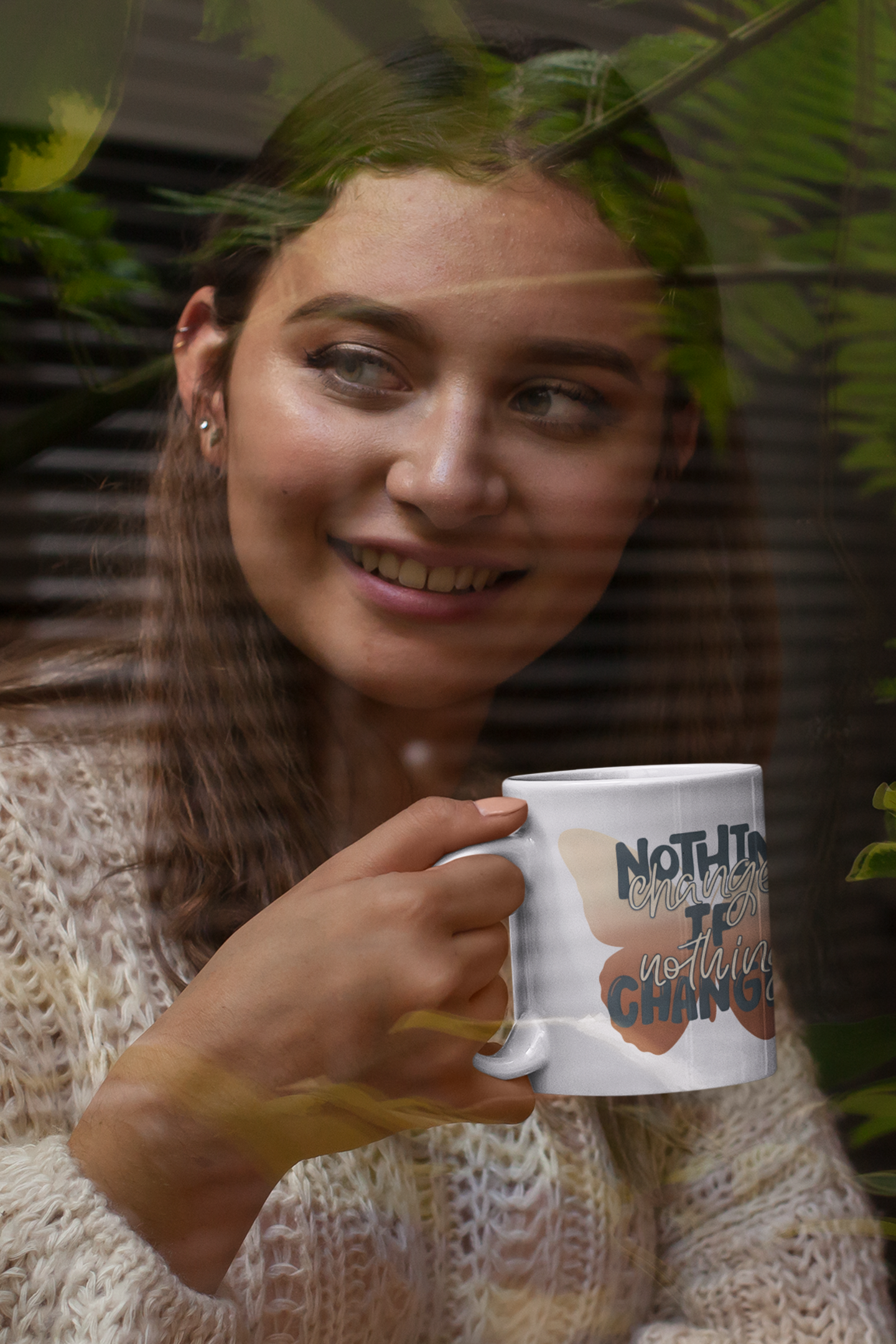 Woman enjoying coffee from a motivational butterfly mug with inspirational mental health quote against a gray background