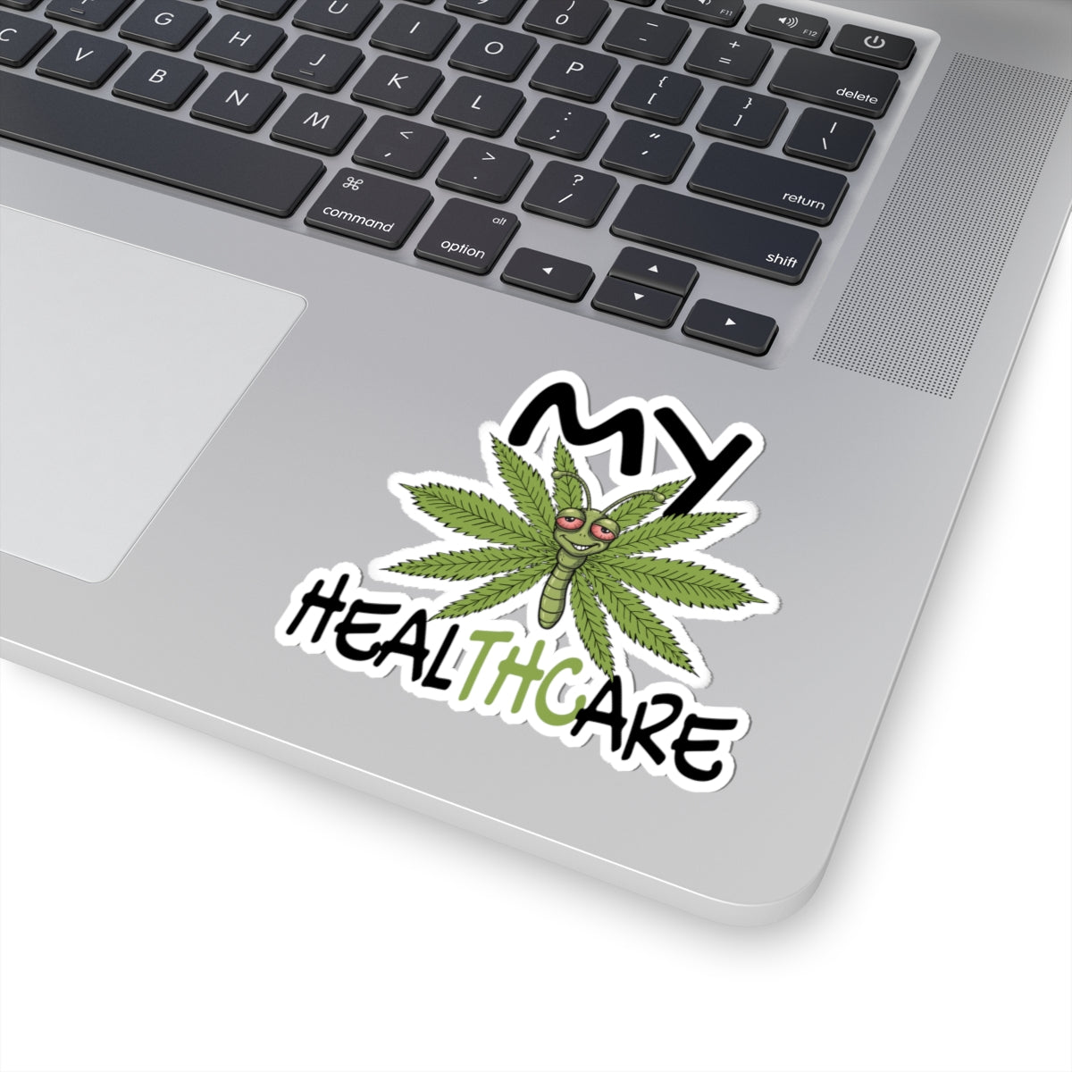 Funny My Healthcare cannabis butterfly vinyl sticker on a laptop palm rest, featuring a marijuana leaf design for weed lovers.