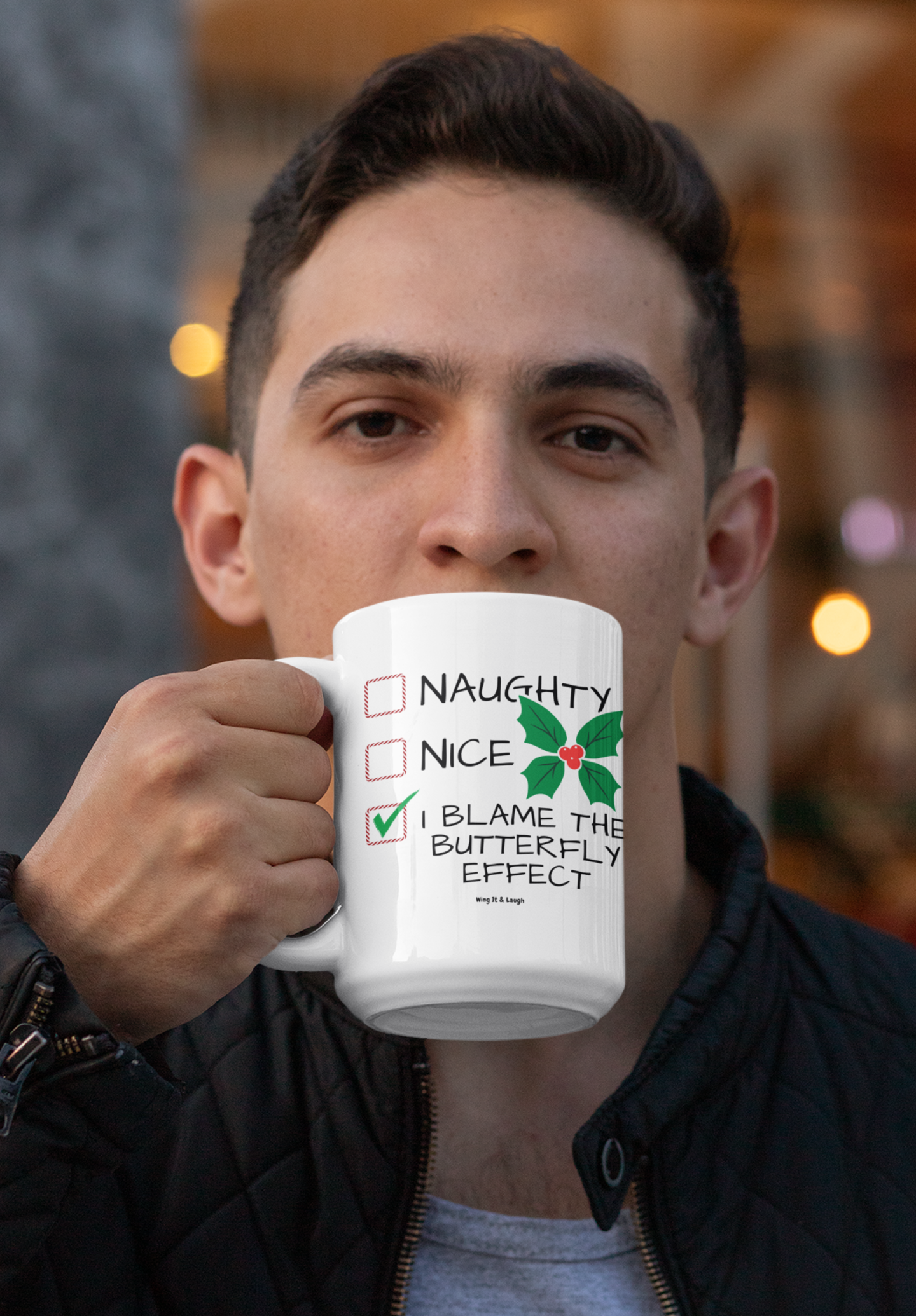 Man drinking from a “Naughty, Nice or Butterfly effect“ Christmas coffee mug