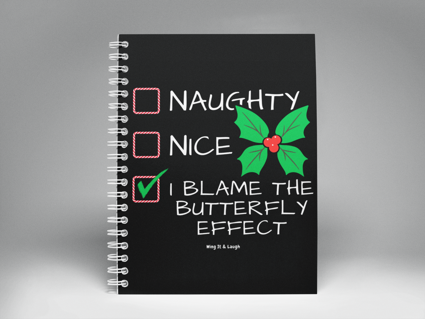 Black notebook with Naughty or nice Christmas checklist on a gray background spiral notebook