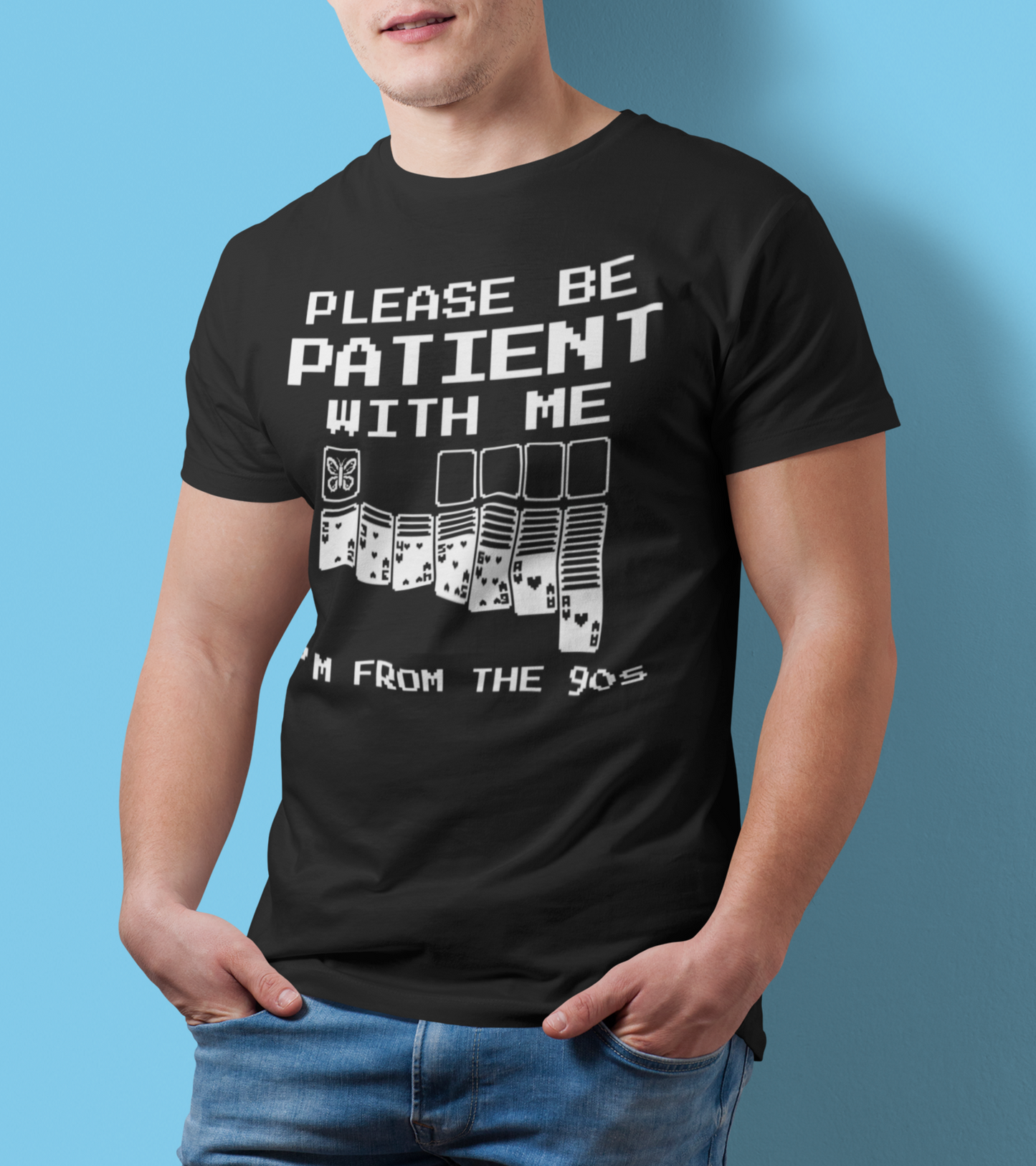 Model wearing funny 90s nostalgia butterfly graphic t-shirt with solitaire card design on a blue background
