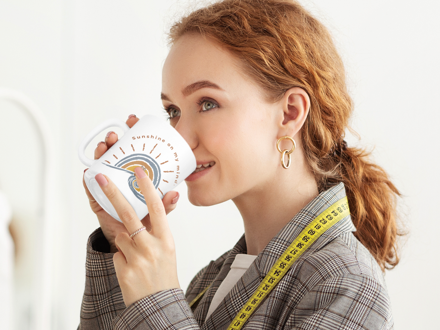 Woman drinking from Sunshine On My Mind butterfly ceramic mug with vintage butterfly sunset design on a white background