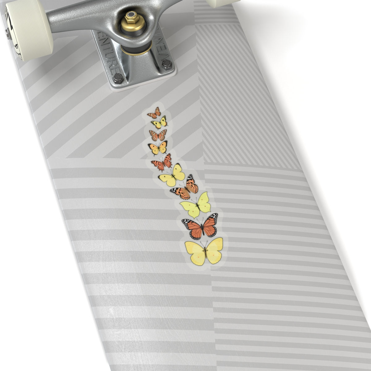 Transparent butterfly sticker with yellow and orange butterflies placed on a skateboard deck.