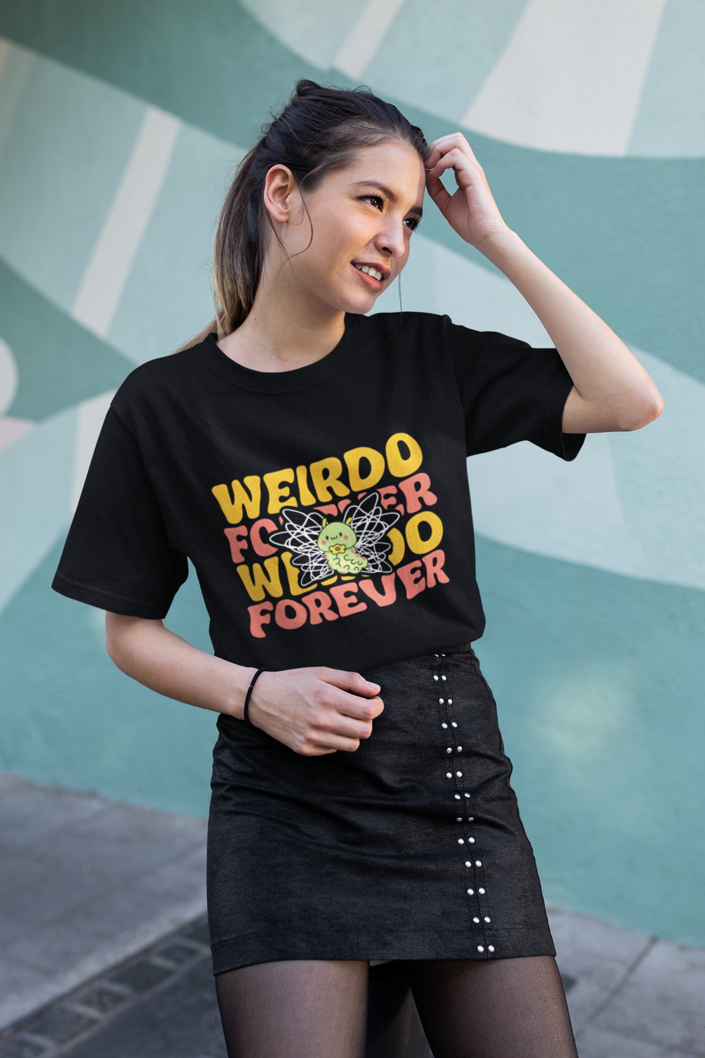 model standing in front of a graffiti wall wearing weirdo forever scribble butterfly black tee