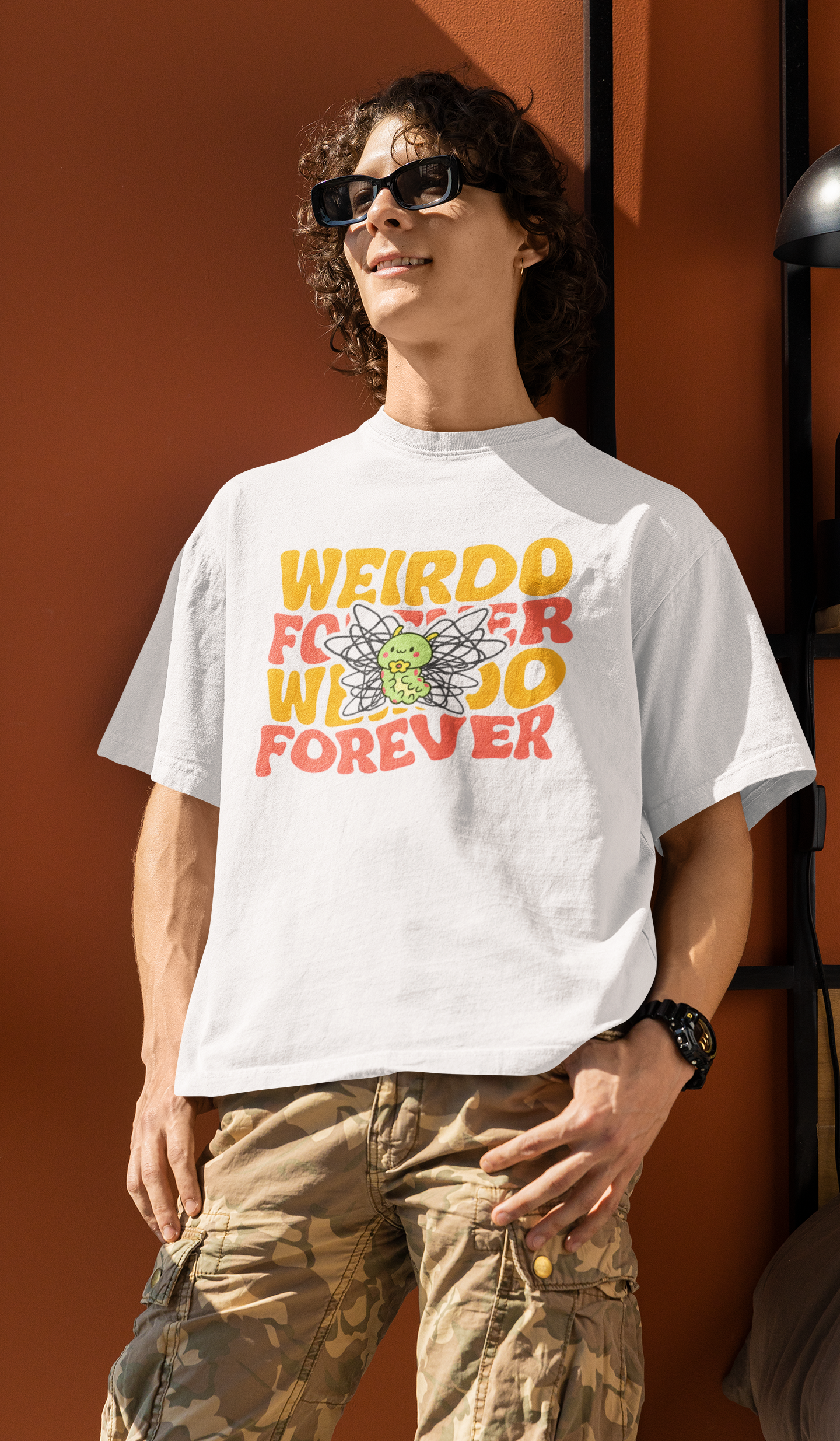 t-shirt mockup featuring a smiling curly-haired male fashion model